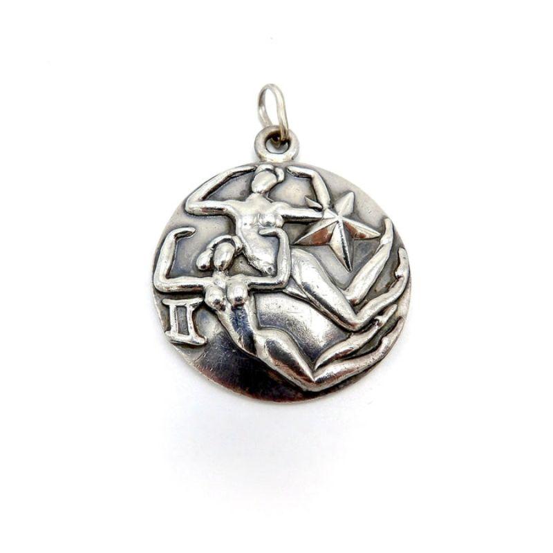 Margot De Taxco Zodiac Sterling Silver Gemini Pendant Medallion, circa 1950
 
Margot de Taxco sterling silver astrological zodiac pieces are bold, stylistic, and streamlined. Margot designed the Zodiac signs in several different series in the 1950s
