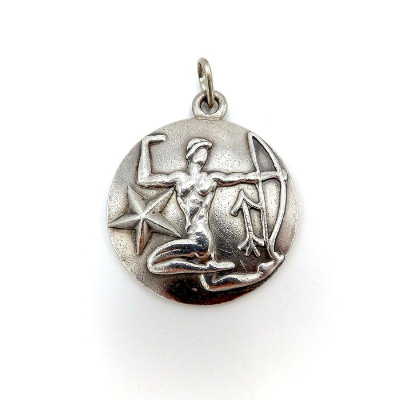 Margot de Taxco sterling silver astrological zodiac pieces are bold, stylistic, and streamlined. Margot designed the Zodiac signs in several different series in the 1950s including this round solid sterling silver set. This pendant depicts the