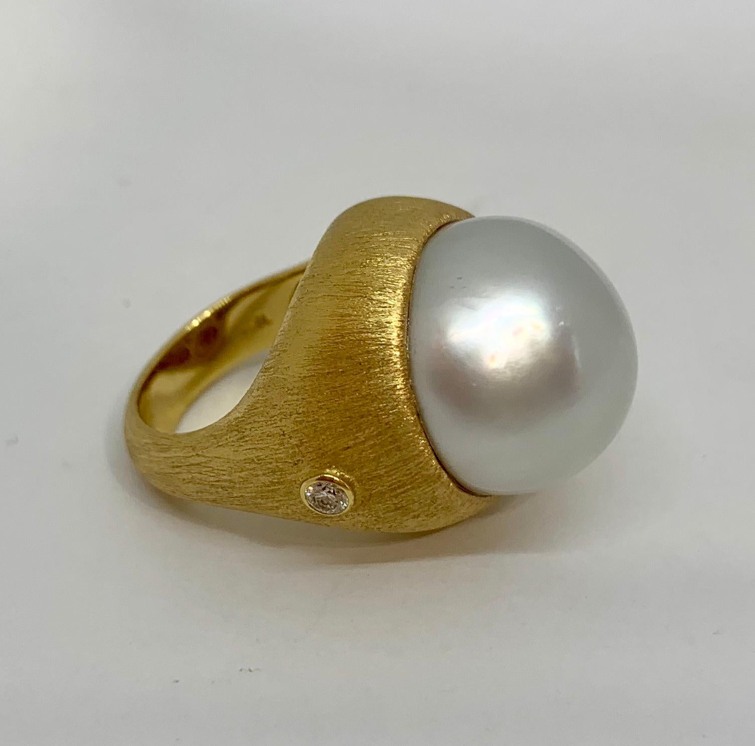 Margot McKinney 18 Karat Brushed Finish Yellow Gold Ring set with a 17mm South Sea Pearl and 2 x 0.15ct round brilliant cut diamonds.
US size 6 1/2  UK/AU size M 1/2