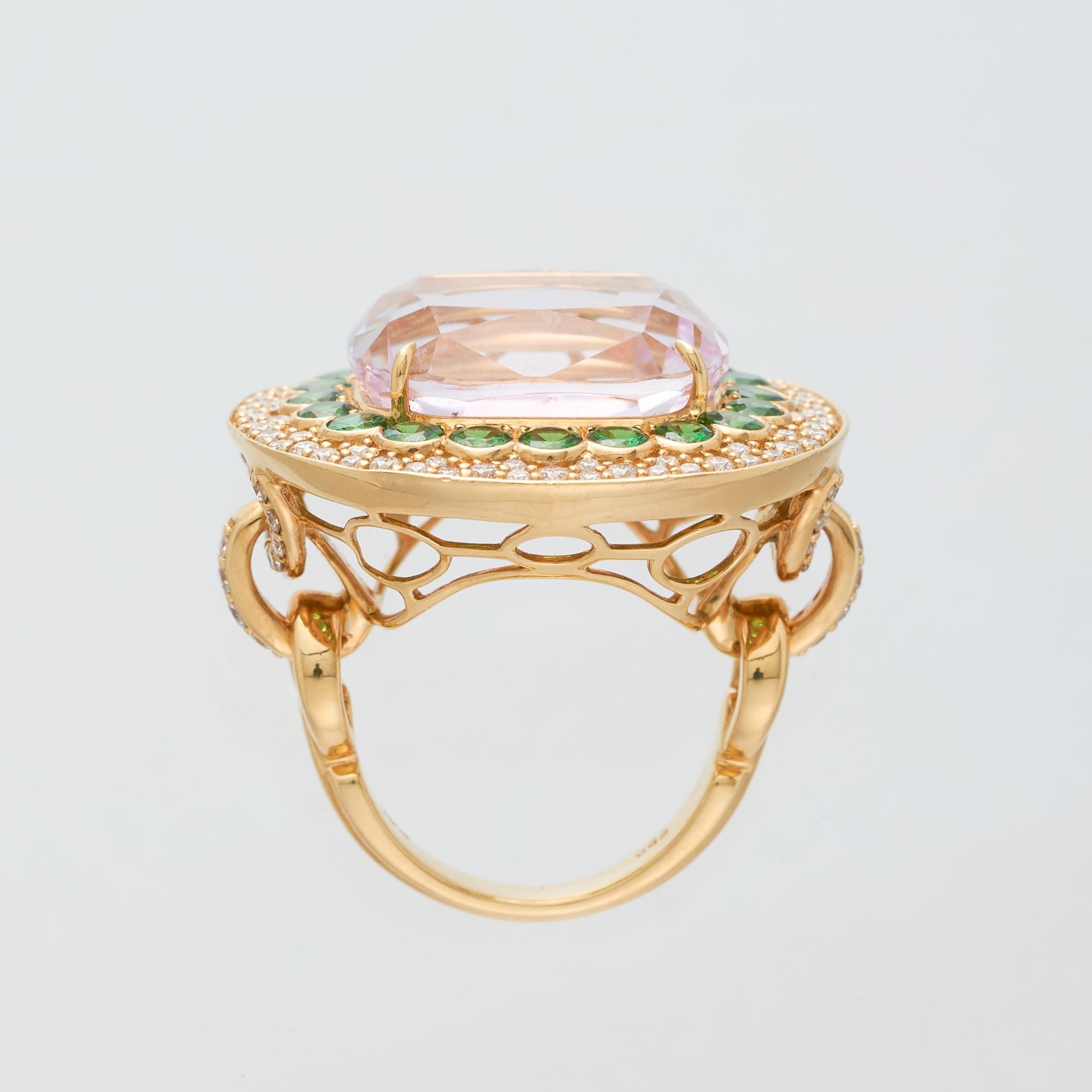 Margot McKinney 18 Karat Yellow Gold Ring set with 1 cushion cut Pink Kunzite weighing in total 23.43ct. The Kunzite is surrounded by a single border of 20  Tsavorites weighing in total 2.51ct and tapering to a double row border of 100 brilliant cut