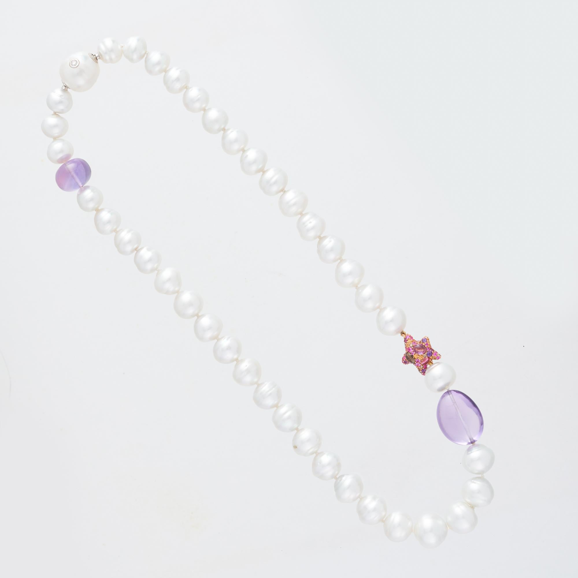 Margot McKinney South Sea Pearl, Star & Amethyst Pebble Necklet, 50cm long  featuring forty 10-14mm silver/white, circle South Sea Pearls, two Amethyst Pebbles, one Diamond and precious stone set 'purple star' enhancer and finished with an