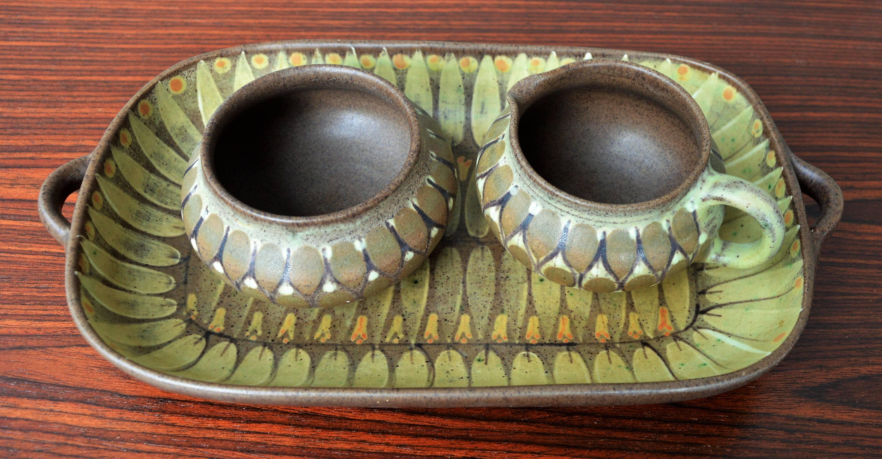 This delightful, rare three-piece ceramic set by Margrethe Dybdahl, Denmark, circa 1960s. These studio pottery pieces are all hand made and hand painted with a delicate feather decor in green, yellow and brown. Marked on the back with the makers