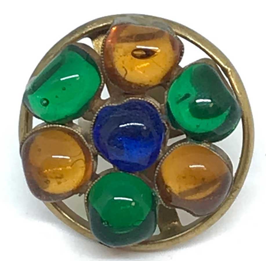 Find all the charm of the old in this ring in aged metal and molten glass in shimmering colors.
Handcrafted in France by artisan jewelers from Maison Marguerite de Valois.
The ring is made of aged gold metal and set with small balls of green, orange