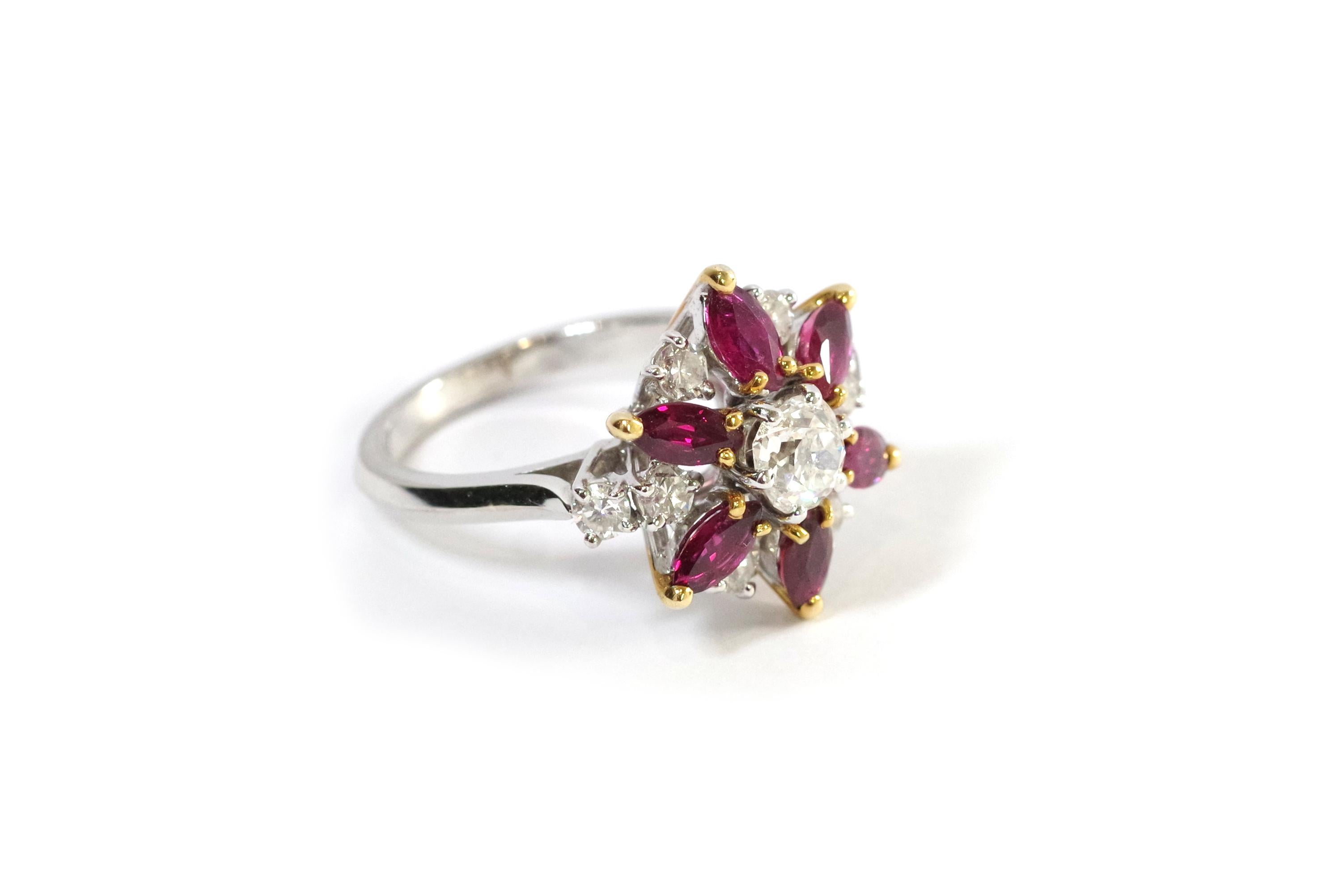 Marguerite diamond ruby ring in 18-karat white gold. The ring features a central significant old mine-cut diamond weighing approximately 0.33 carats. The diamond is surrounded by six marquise-shaped rubies and four brilliant-cut diamonds. The rubies