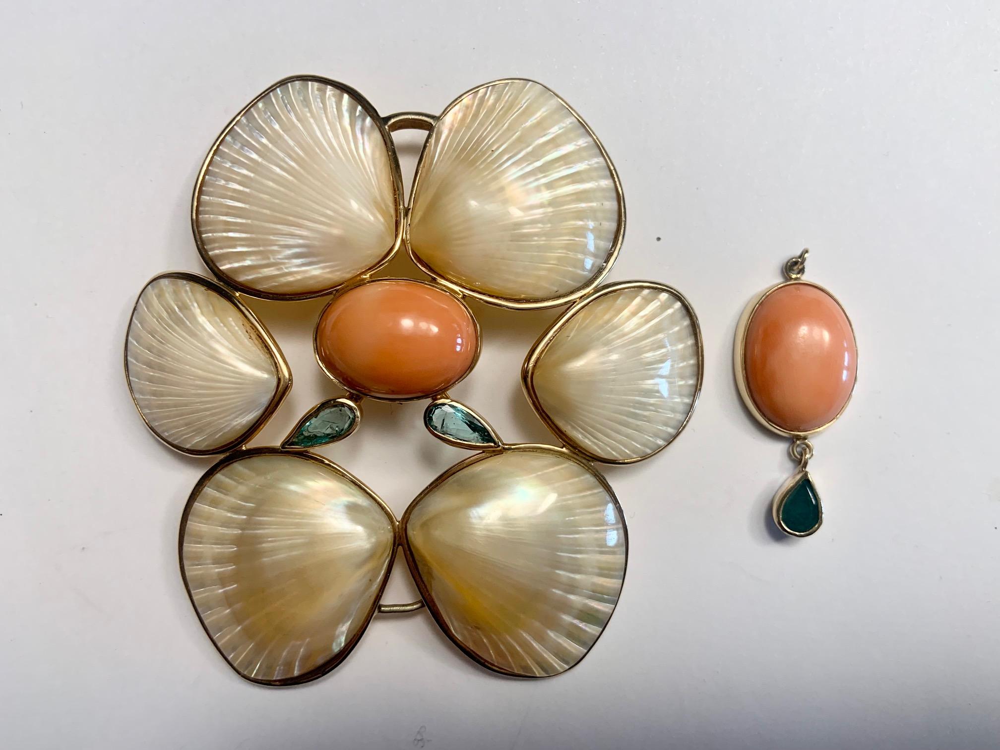 Elegant and versatile this four shell pin designed by Marguerite Stix has two faceted emeralds in the center and a large cabochon coral and emerald drop  below. The brooch can be worn as a pin or a pendant, a pin without the coral drop, and the