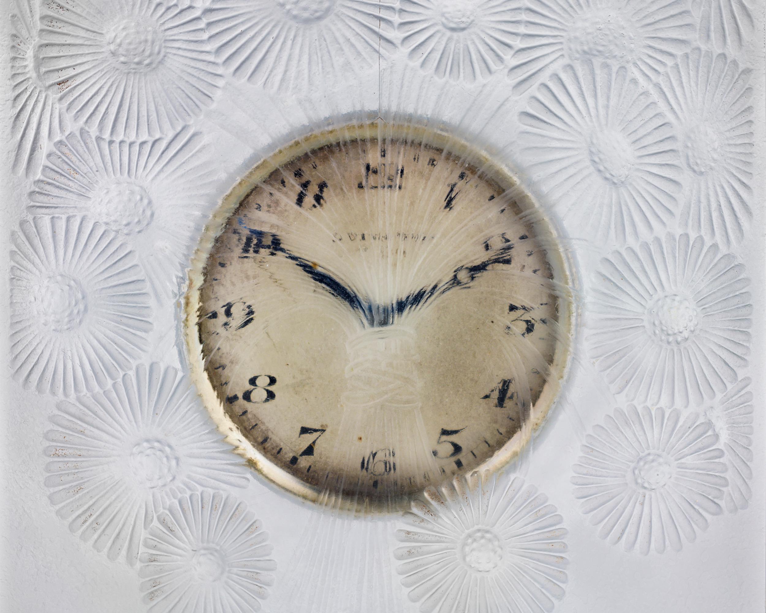 This stunning frosted glass clock by René Lalique was made circa 1920 and features the Marguerites pattern, which translates to daisy, symbolizing innocence and purity. A bouquet bursts from the center of the refined gilt clock face, with each