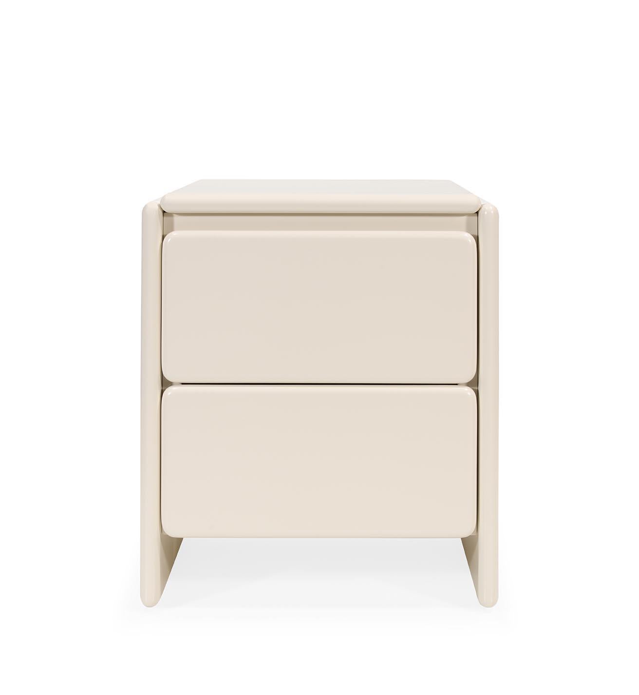 Mari Bedside Table: Soft Curves in Lacquered Elegance

The Mari Bedside Table combines sleek lacquered surfaces with soft, flowing curves that wrap around its form, creating a sophisticated and serene presence. Featuring two spacious drawers with a
