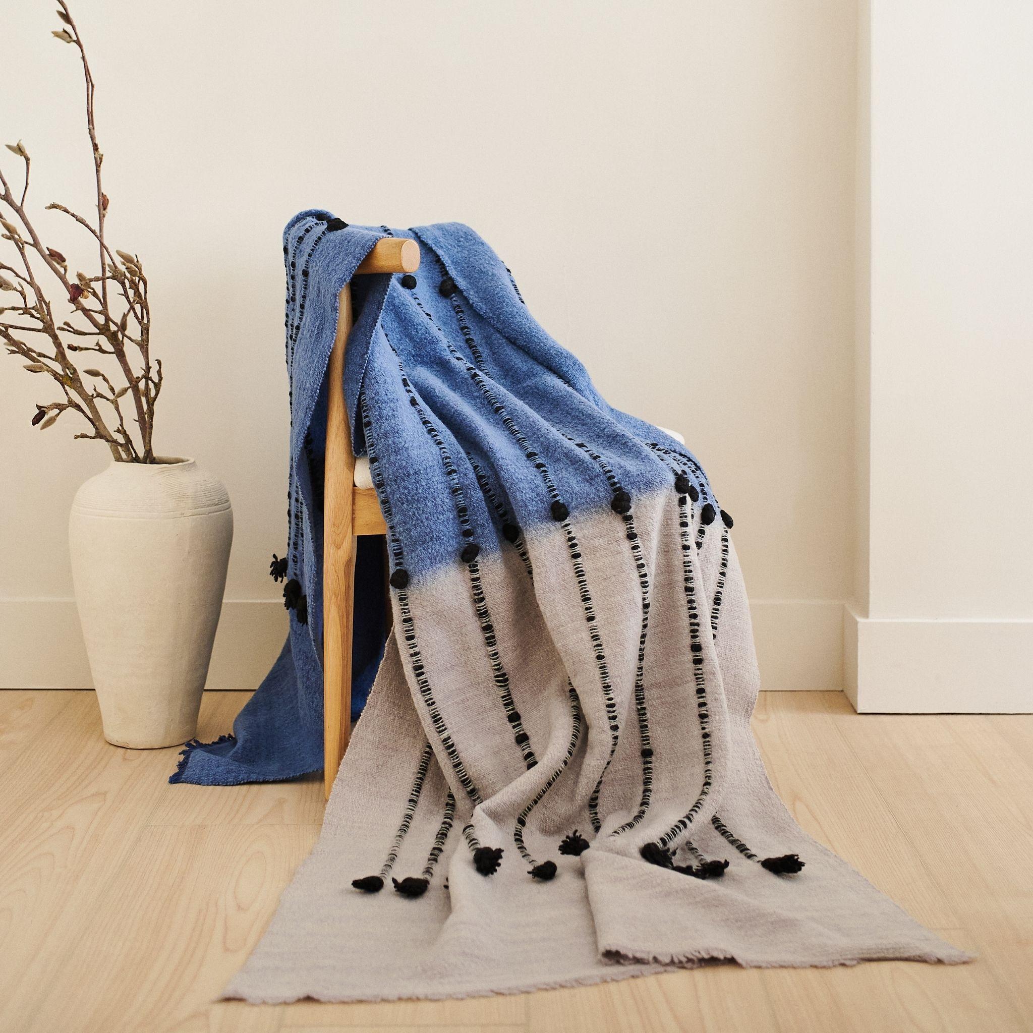A calming reflection of the lakeside skies with pleasing color choices and textural details all created meticulously by expert artisans is what Mari Throw is all about. Modern harmony brought to life with locally sourced hand spun merino from the