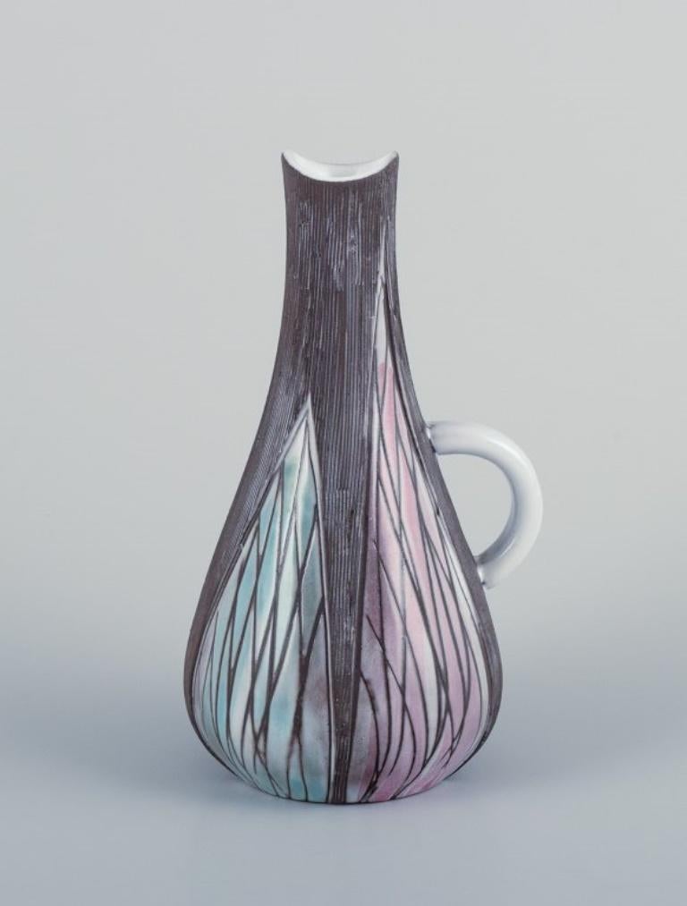 Mari Simmulson (1911-2000) for Upsala Ekeby, Sweden. 
Ceramic vase and pitcher in modernist style with abstract motifs.
Approximately from the 1960s.
Model number 4453 + 4415.
In perfect condition.
Marked.
Vase 4415: W 9.5 cm x H 19.0 cm.

Mari