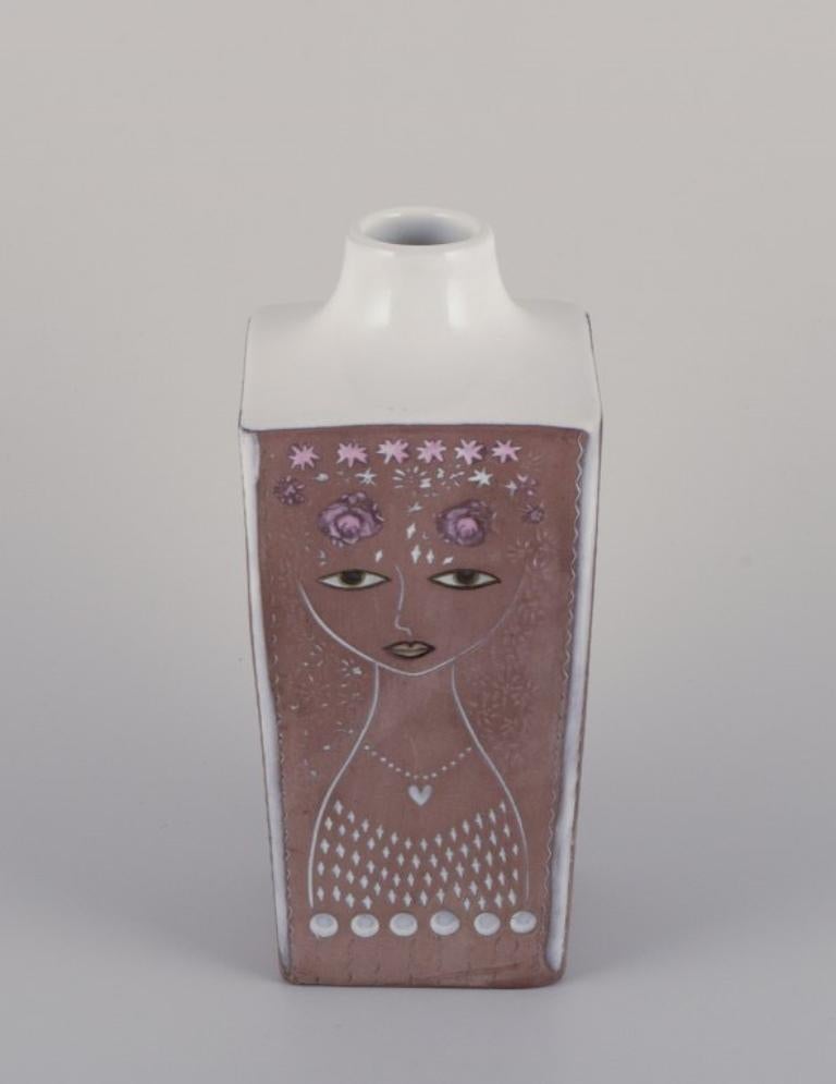Mari Simmulson (1911-2000) for Upsala Ekeby, Sweden. 
Ceramic vase in a square shape. Floral and female motif.
Approximately from the 1960s.
Model number 43130/955.
Marked.
In perfect condition.
Dimensions: H 23.2 cm x D 9.5 cm.

Mari Simmulson is