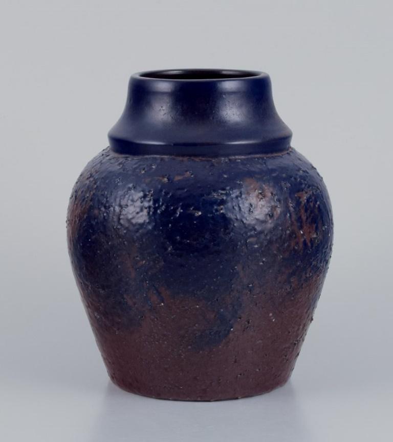 Mari Simmulson (1911-2000) for Upsala Ekeby, Sweden. 
Ceramic vase with glaze in blue and brown tones.
Approximately 1960.
Marked.
Perfect condition.
Dimensions: H 19.5 cm x D 14.0 cm.

Mari Simmulson is recognized as a prominent figure in the
