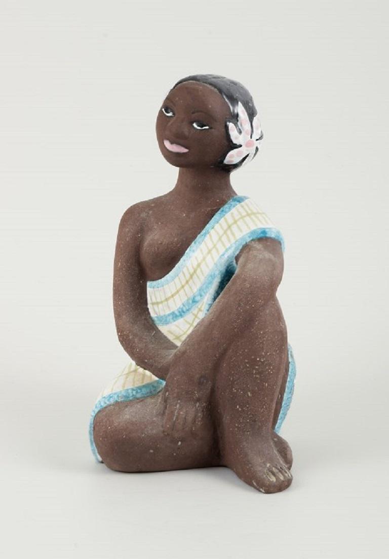 Mari Simmulson for Upsala-Ekeby. Rare ceramic figure of a semi-naked Tahitian woman. 
Approx. 1960
Measurements: H 19 cm. x D 9.5 cm.
In excellent condition.
Marked.
 