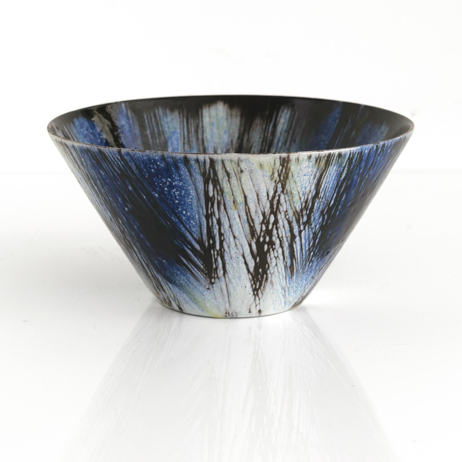 A Mari Simmulsson “cross-hatched” glazed bowl in blue, black and touches of yellow, for Upsala Ekeby, Sweden, circa 1950’s. Scandinavian Modern.

Measures: Diameter: 9“ Height: 4.5”.