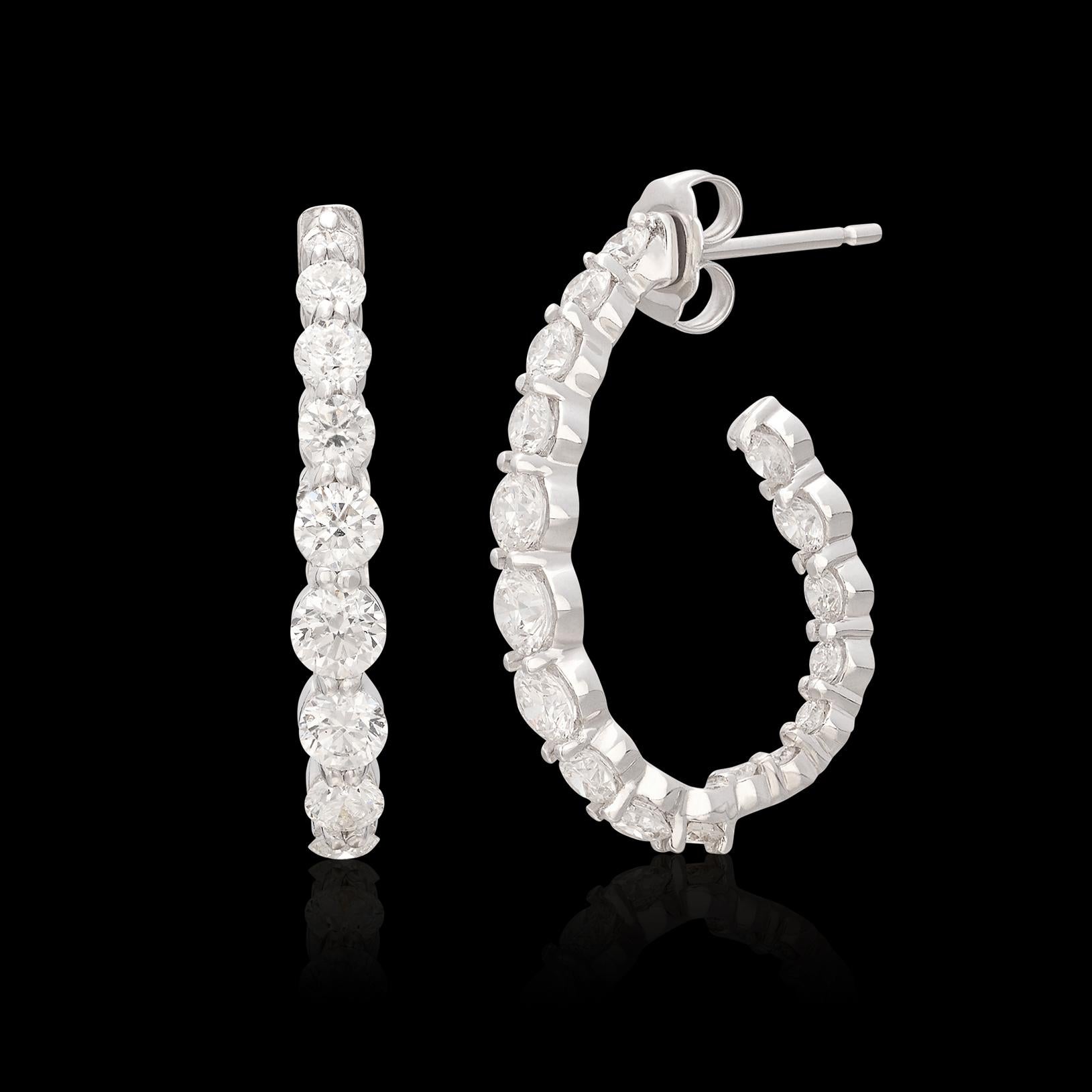 This pair of 18k white gold inside/out hoops by Maria Canale have a lovely unique twist - they are designed with graduated diamonds, prong-set set so that they appear to be floating down the ear! Set with 36 round brilliant-cut diamonds weighing a