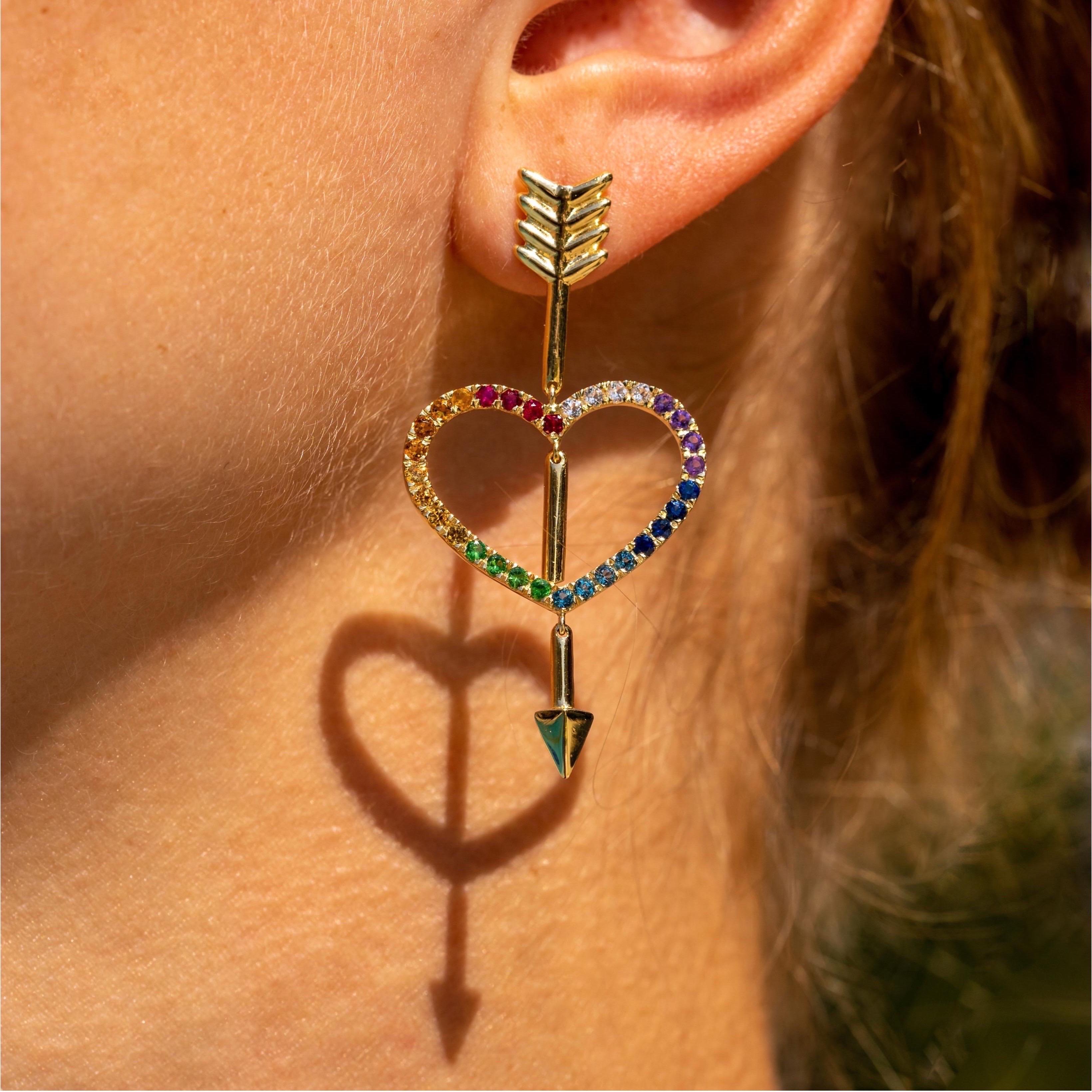 The ‘Lovestruck rainbow’, ear pendants are crafted in 18K gold hallmarked in Cyprus. These impressive, playful, articulated ear pendants come in a highly polished finish and feature rainbow colored gemstones including Rubies, Yellow and Blue