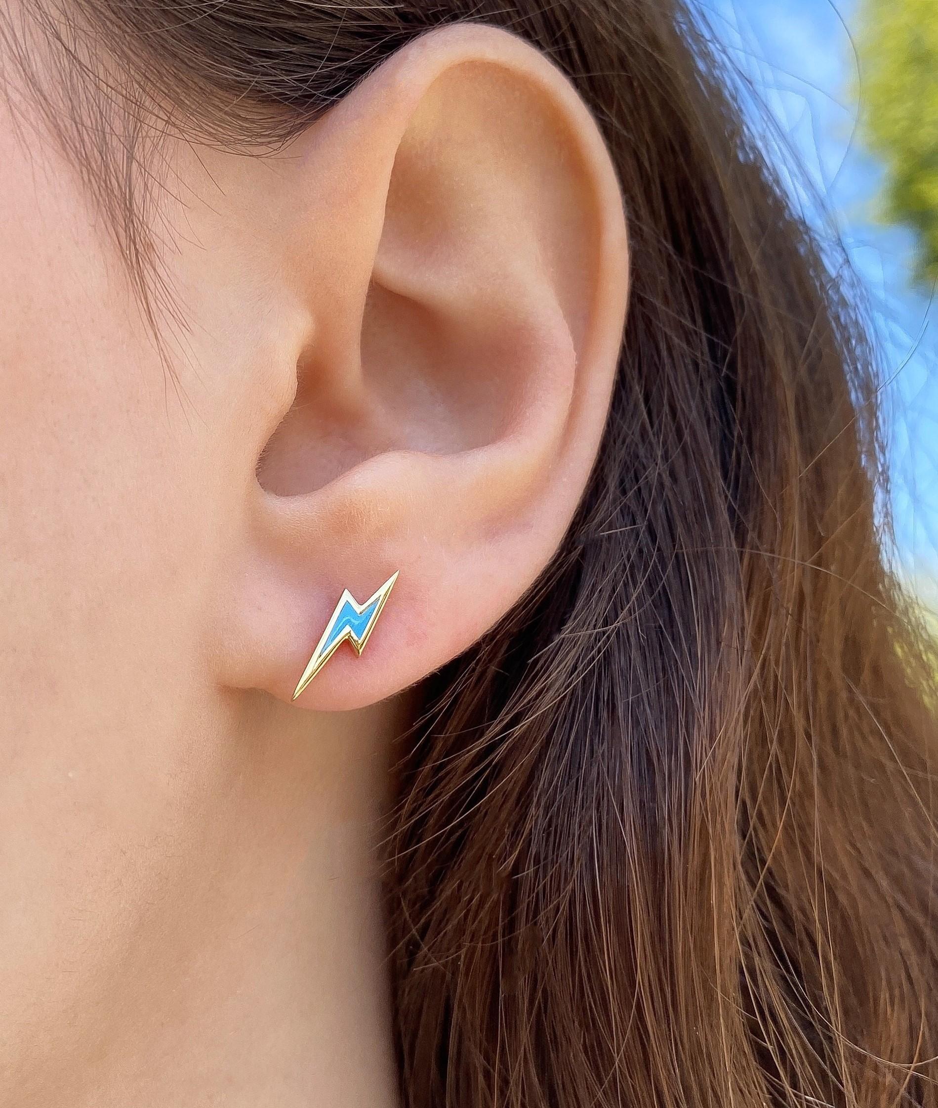 The Lighting bolt, ear studs are crafted in 18K yellow gold, hallmarked in Cyprus. These adorable studs come in a highly polished finish and come in two stunning options; a vibrant orange or a serene blue enamel, making them a perfect match for any