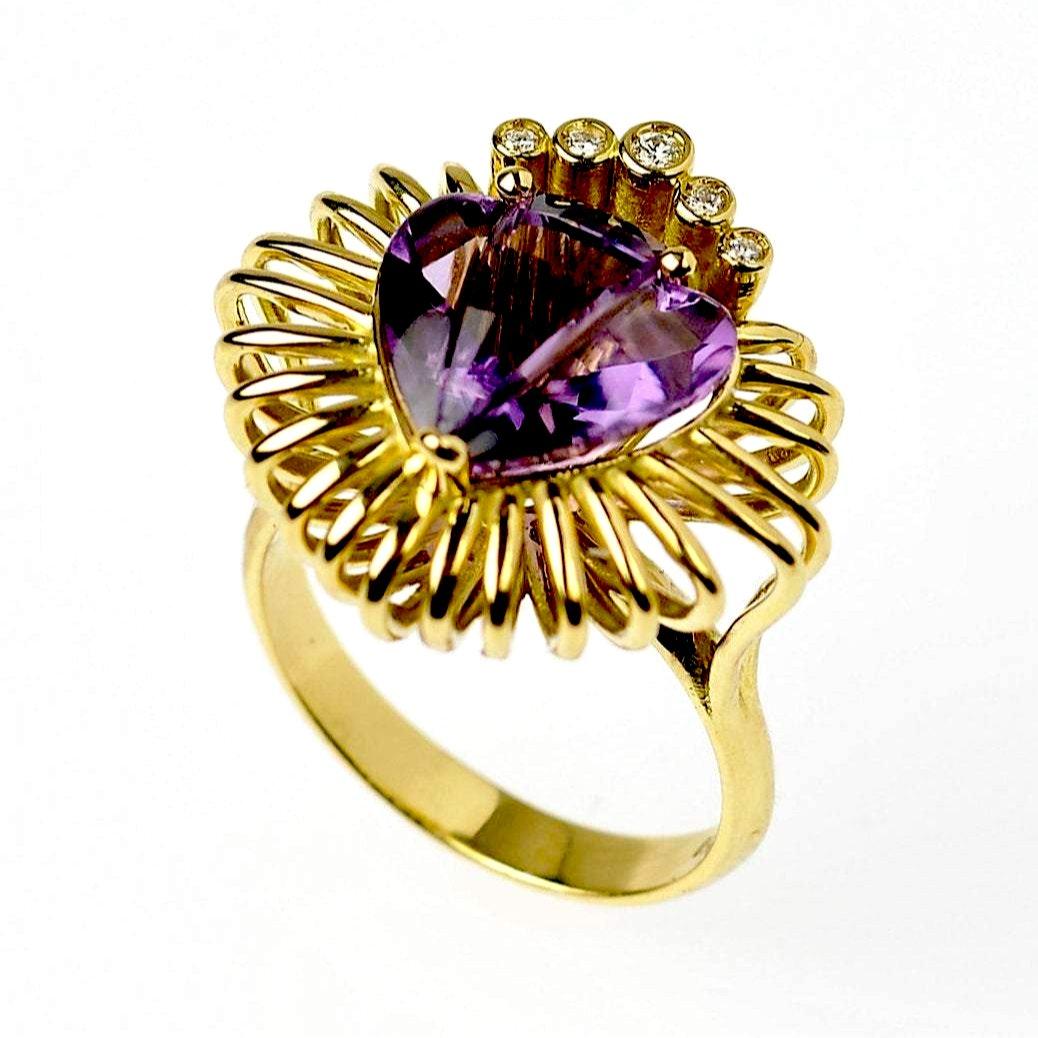 The ‘Pulsating Heart’ ring is crafted in 18k gold, hallmarked in Cyprus. At the centre of this statement ring, you will find a stunning 4.43 cts, antique cut, heart shaped Amethyst. This unique gemstone is known to evoke feelings of serenity, inner