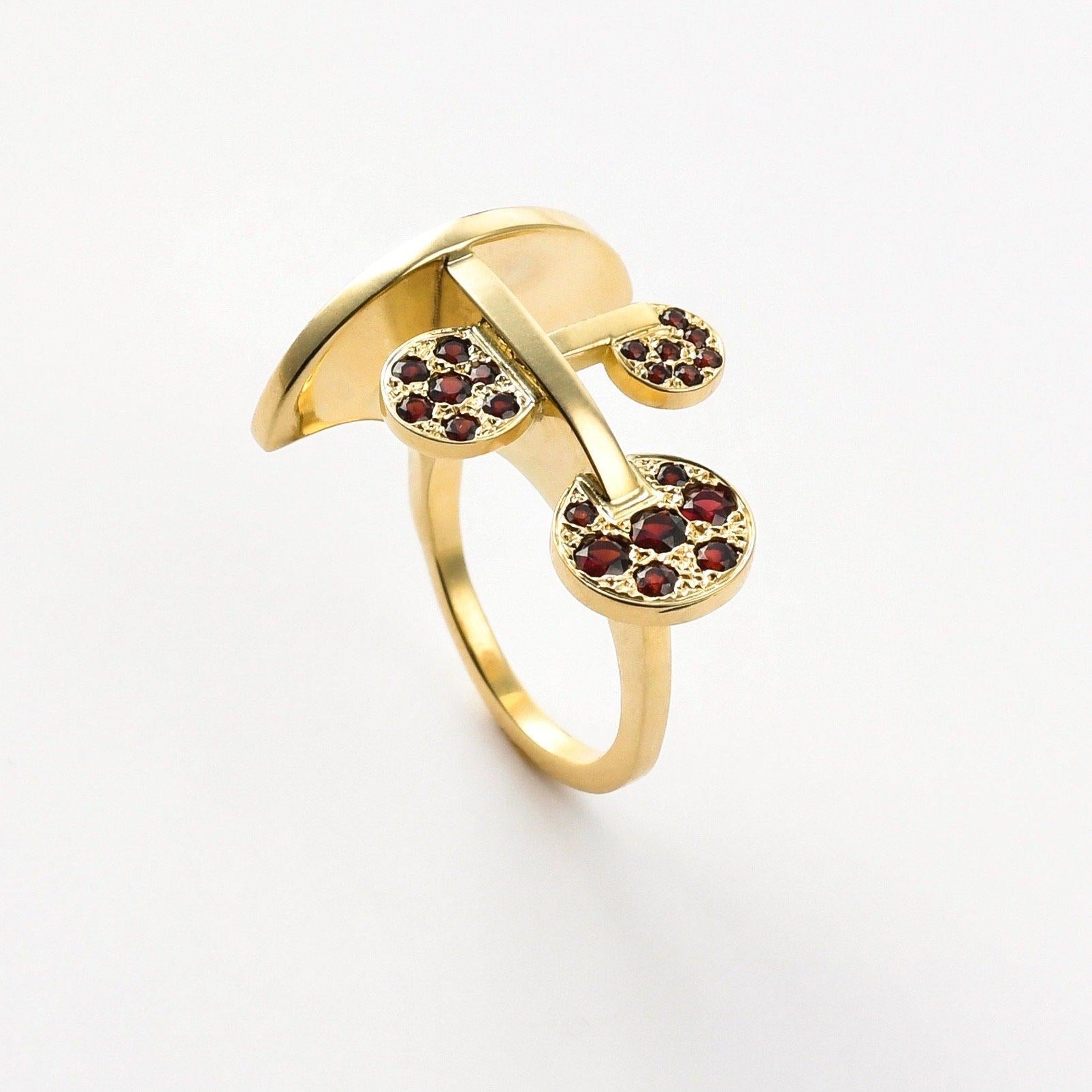 The 'Hovering Disk’, ring is crafted in 18k gold, hallmarked in Cyprus. This innovative, contemporary, sculptural ring, comes in a highly polished finish and features Wine Red Garnets totalling 0,5 Cts. Equally impressive on an end or middle finger,