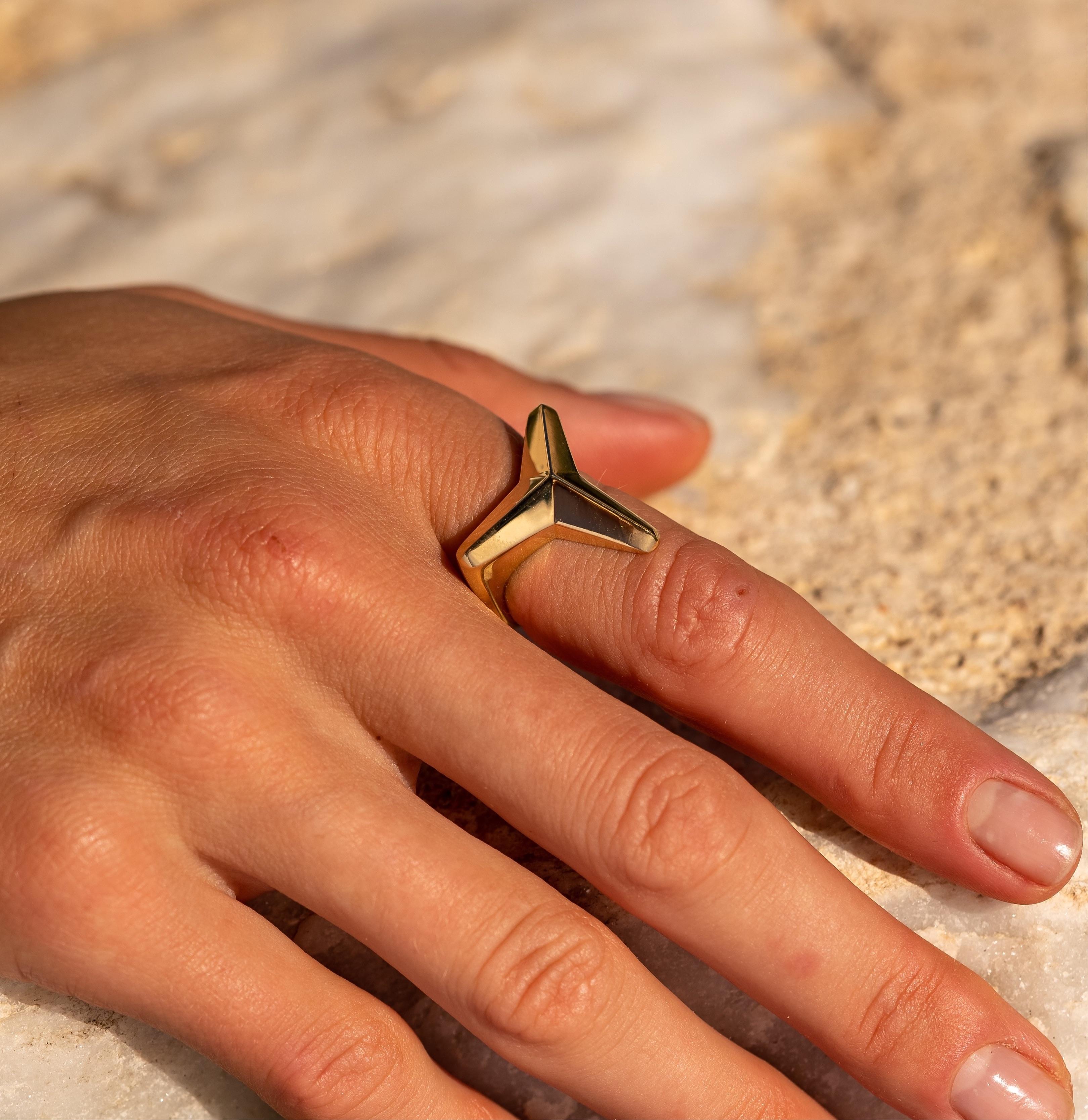The stunning Three pointed star ring is made of 18K yellow gold and is hallmarked in Cyprus. This highly polished finish ring is the perfect balance of style and comfort. It will look equally great worn as a ring on the pointer or middle finger and