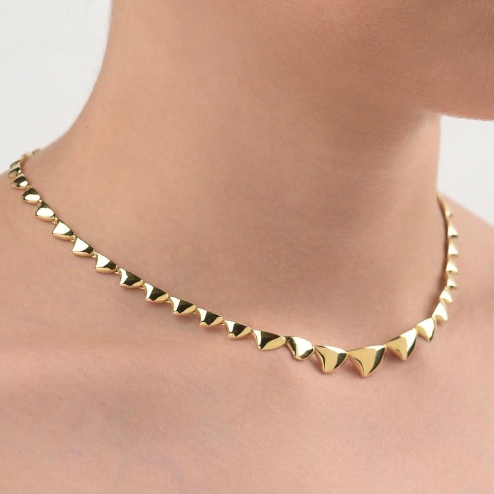 The ‘Spiked’ necklace is crafted in 18K yellow gold, hallmarked in Cyprus. This elegant, articulated, sculptural necklace, comes in a highly polished finish and is composed of degrading spiked parts, masterfully linked between them to allow a