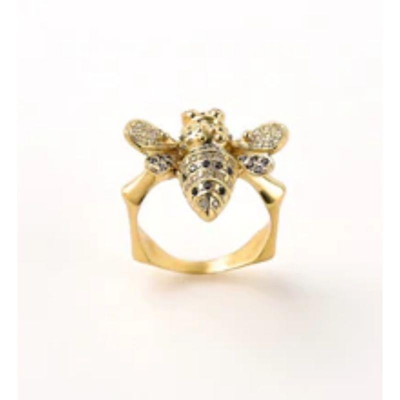 The ‘Flying Bee’, ring is hand sculpted and crafted in 18k yellow Gold, hallmarked in Cyprus. This stricking statement ring, comes in a highly polished finish and is set with 0.092 cts. Black and 0.17 cts. White Diamonds. The Bee is symbolic of