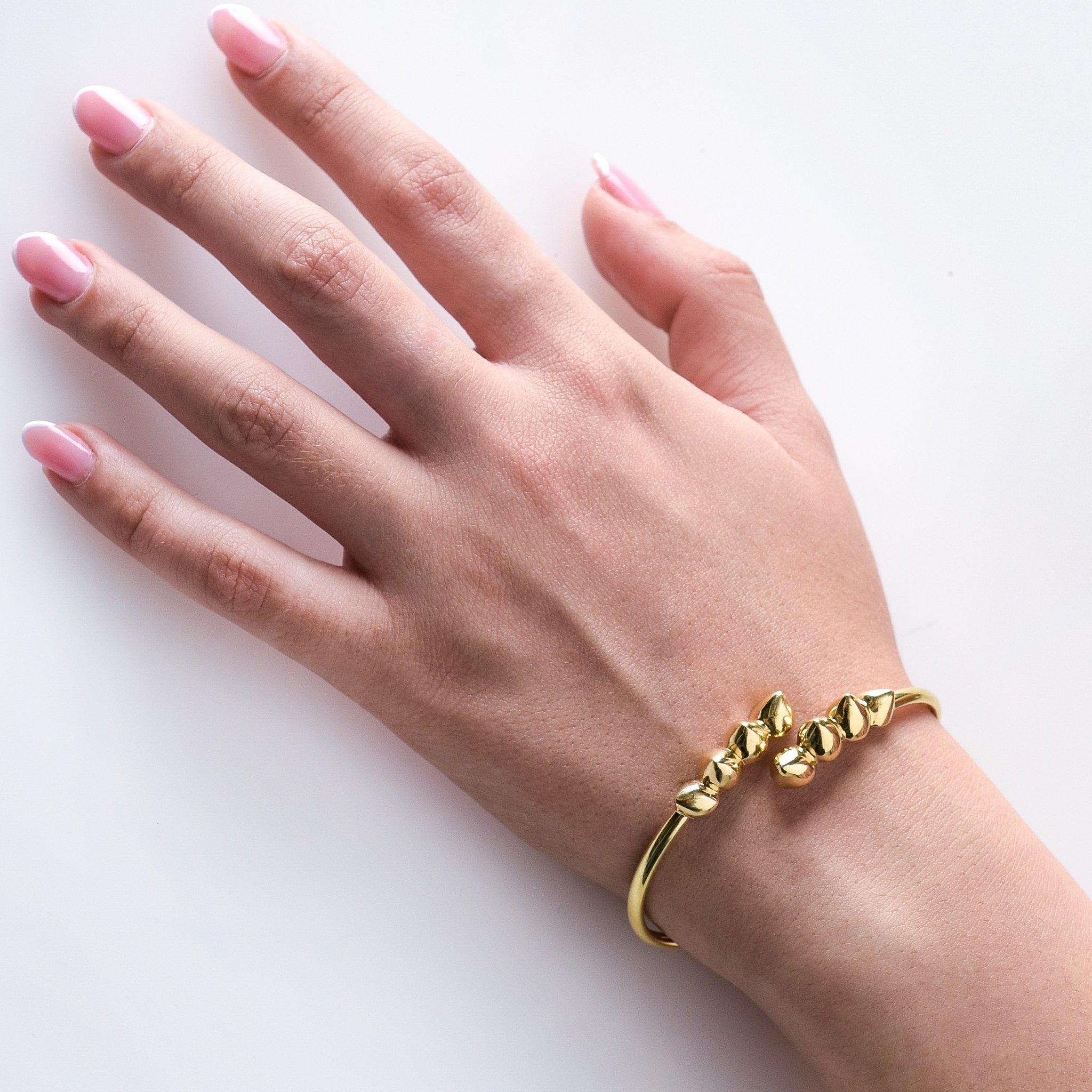 The ‘Eight Spike’, flexible cuff is hand sculpted and crafted in 18K yellow gold, hallmarked in Cyprus. This elegant, statement cuff, comes in a highly polished finish and is composed of sculptural parts and flexible tube which makes it very