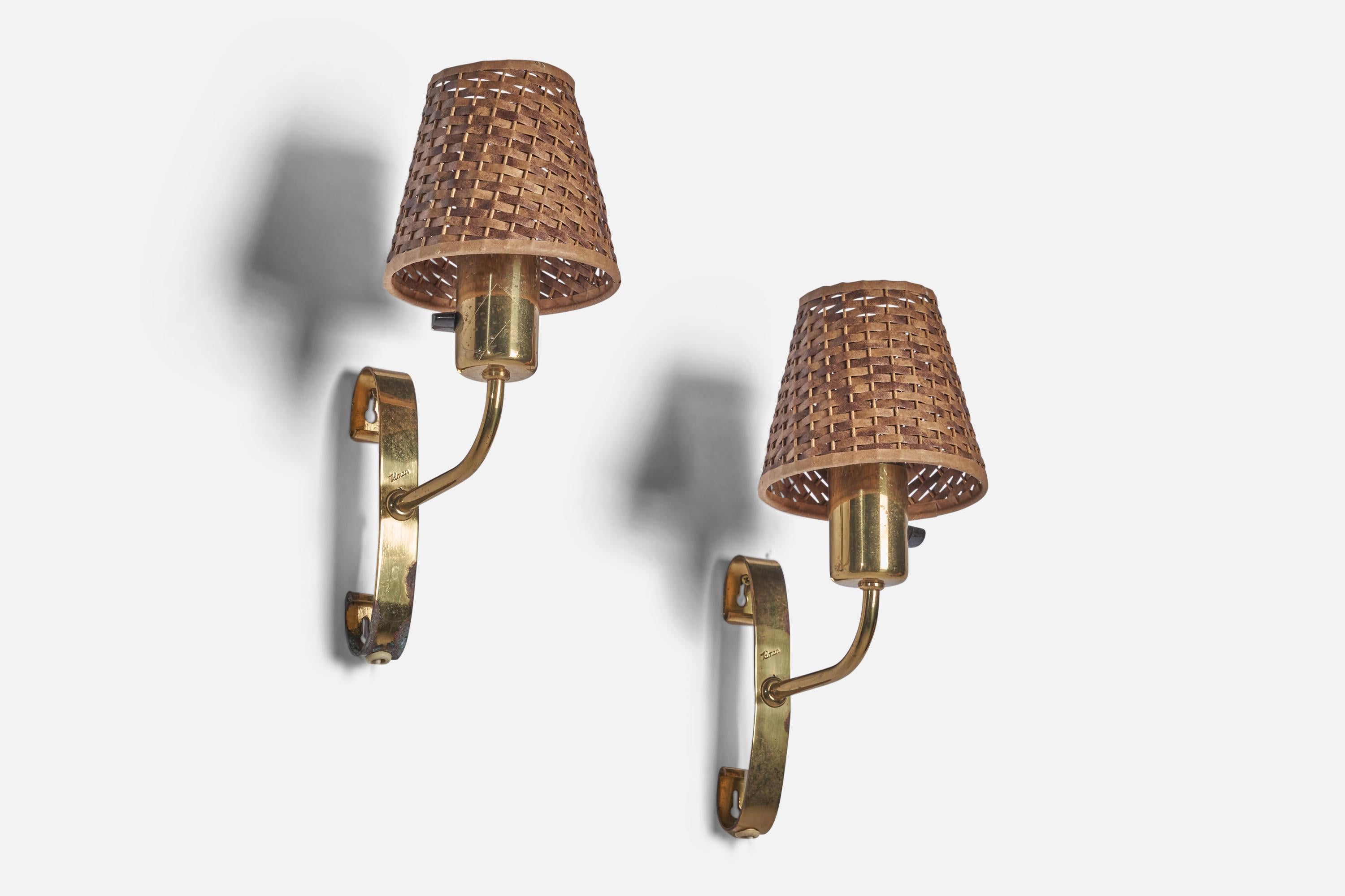 A pair of brass and rattan wall lights designed by Maria Lindeman and produced by Idman, Finland, c. 1950s.

Overall Dimensions (inches): 12” H x 5” W x 8.5” D
Back Plate Dimensions (inches): 6.5” H x 1” W x 1.5” D
Bulb Specifications: E-26