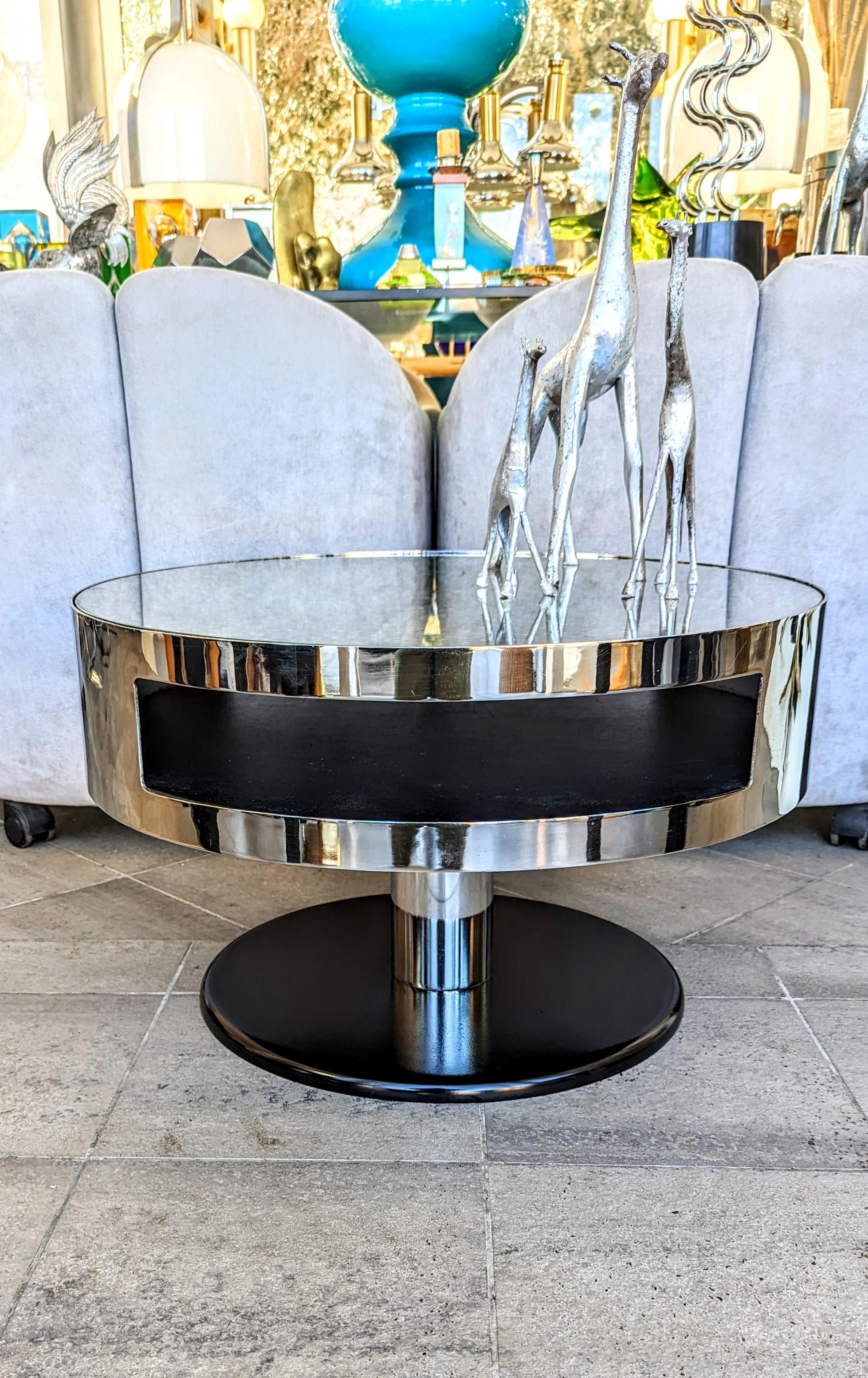 Rare and beautiful end table attributed yo María Pergay, and manufactured in France in 1970s. The table is made of very high quality, it is placed on a black cast iron foot, topped with a chrome cylinder then a large chrome metal top with two large