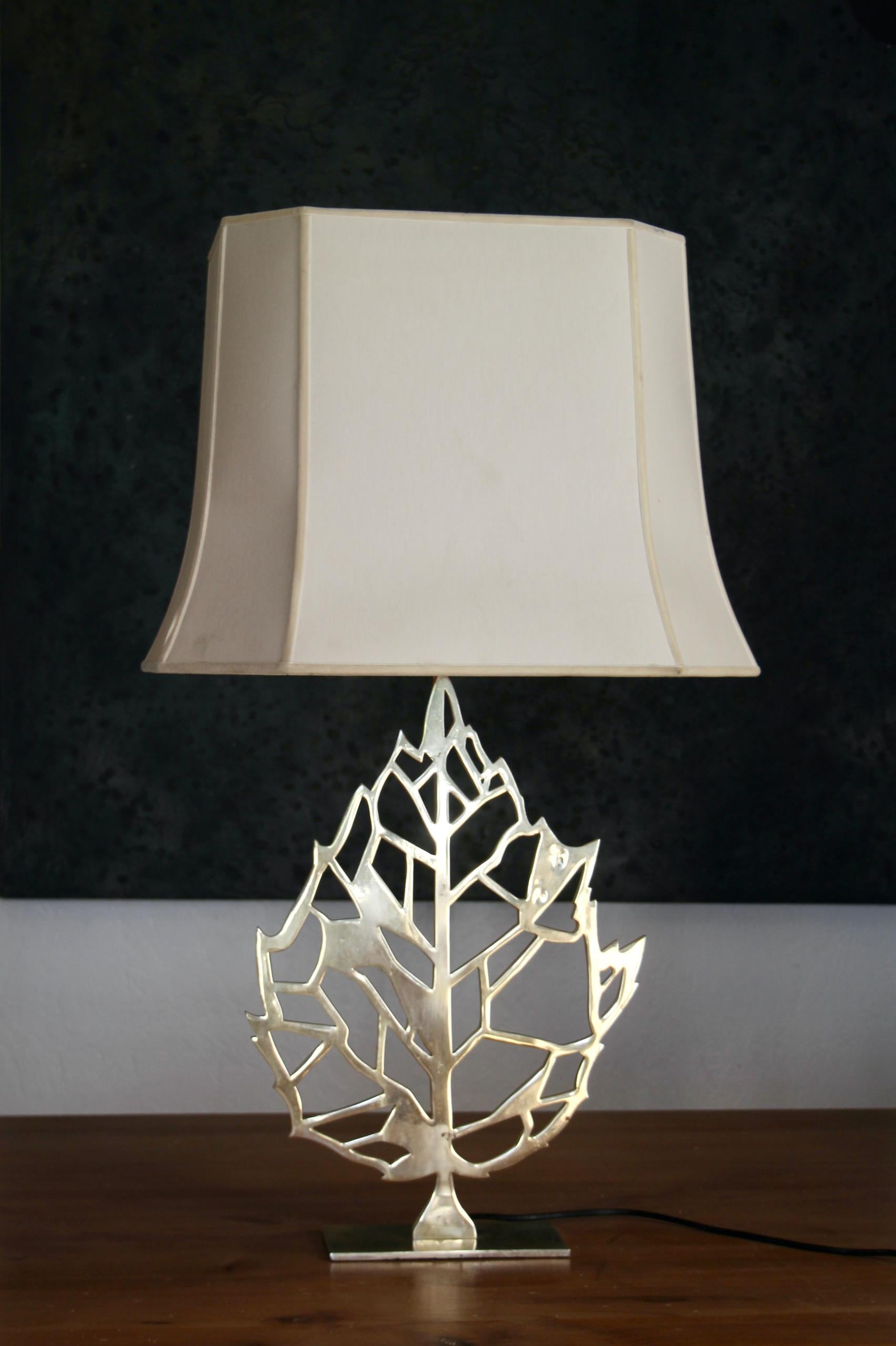 Maria Pergay lamp with gold metal leaf. There are some stains on the lamp base due to corrosion, some small stains on the shade , dimensions with shade are H 87 by 40 by 50 cm 