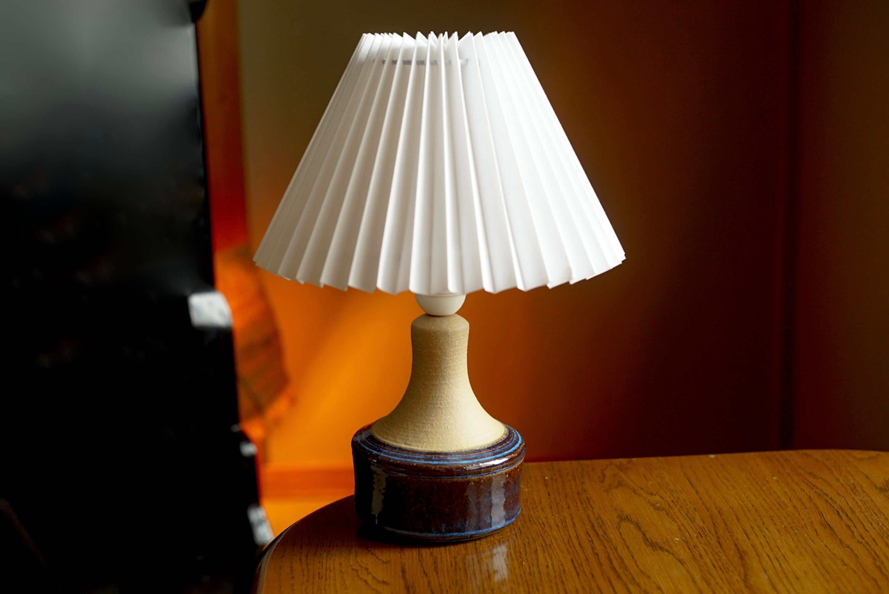 A table lamp produced by Søholm Keramik, located on the island of Bornholm in Denmark. Features a highly artistic glazed and incised decor.

Sold without lampshade. Stated dimensions exclude the lampshade. Height includes socket.