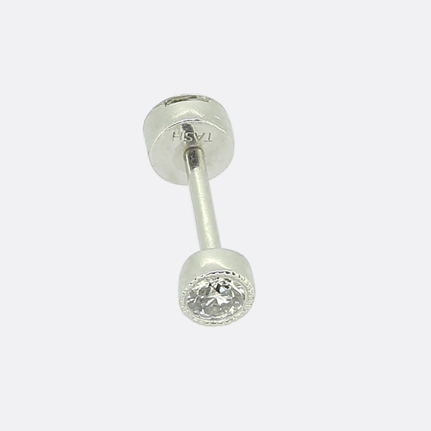 Here we have a wonderful 18ct white gold diamond stud earring from the contemporary jeweller Maria Tash. The earring features a 0.24 carat round brilliant cut diamond that sits in the 'invisible' mount. This earring also has a diamond set post or