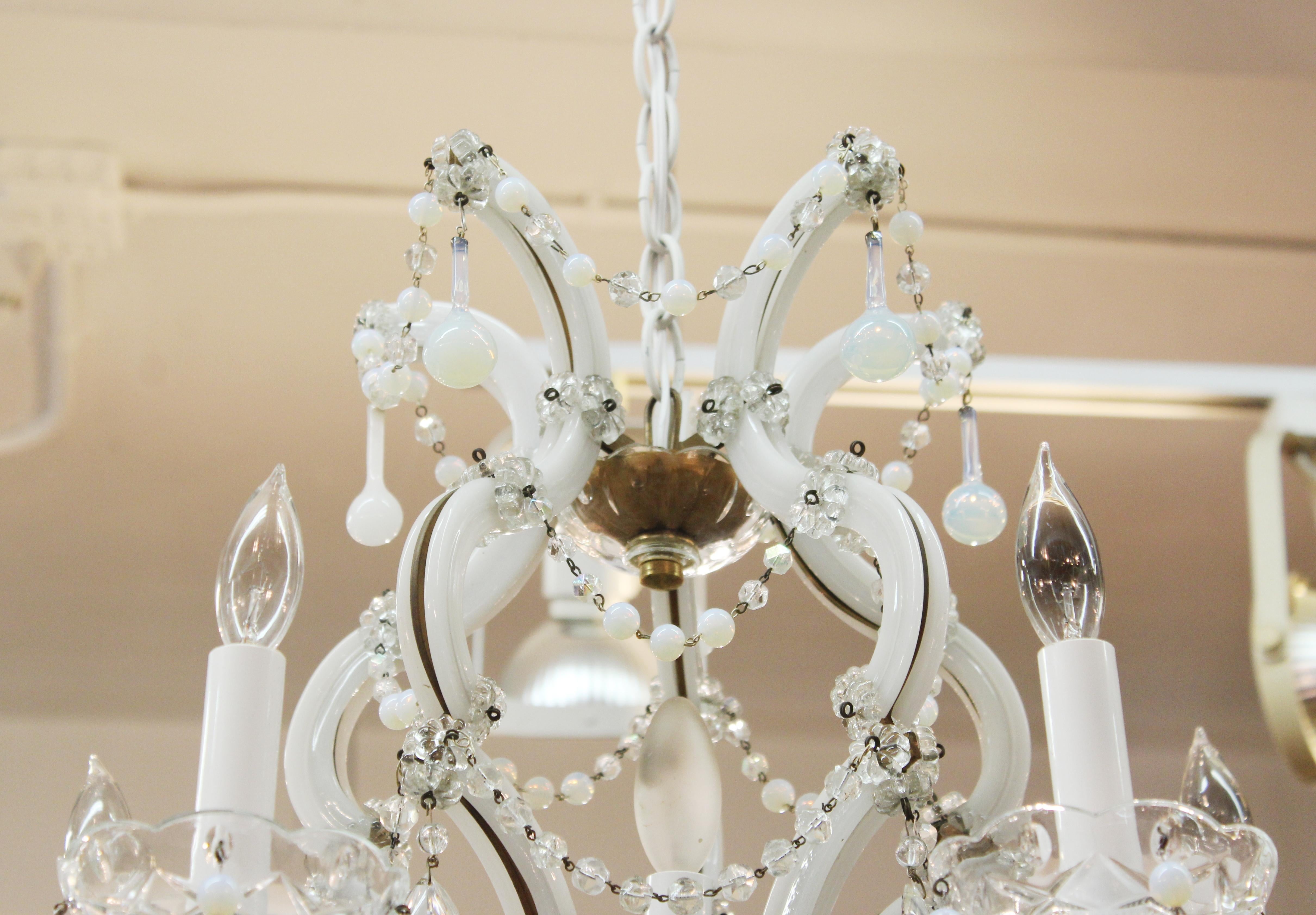 Maria Teresa rare brass chandelier with milk glass frame, clear crystal pendants, opalescent glass acorn pendants and crystal and opalescent garlands. Made in Italy during the 1950's and recently rewired. In great vintage condition with