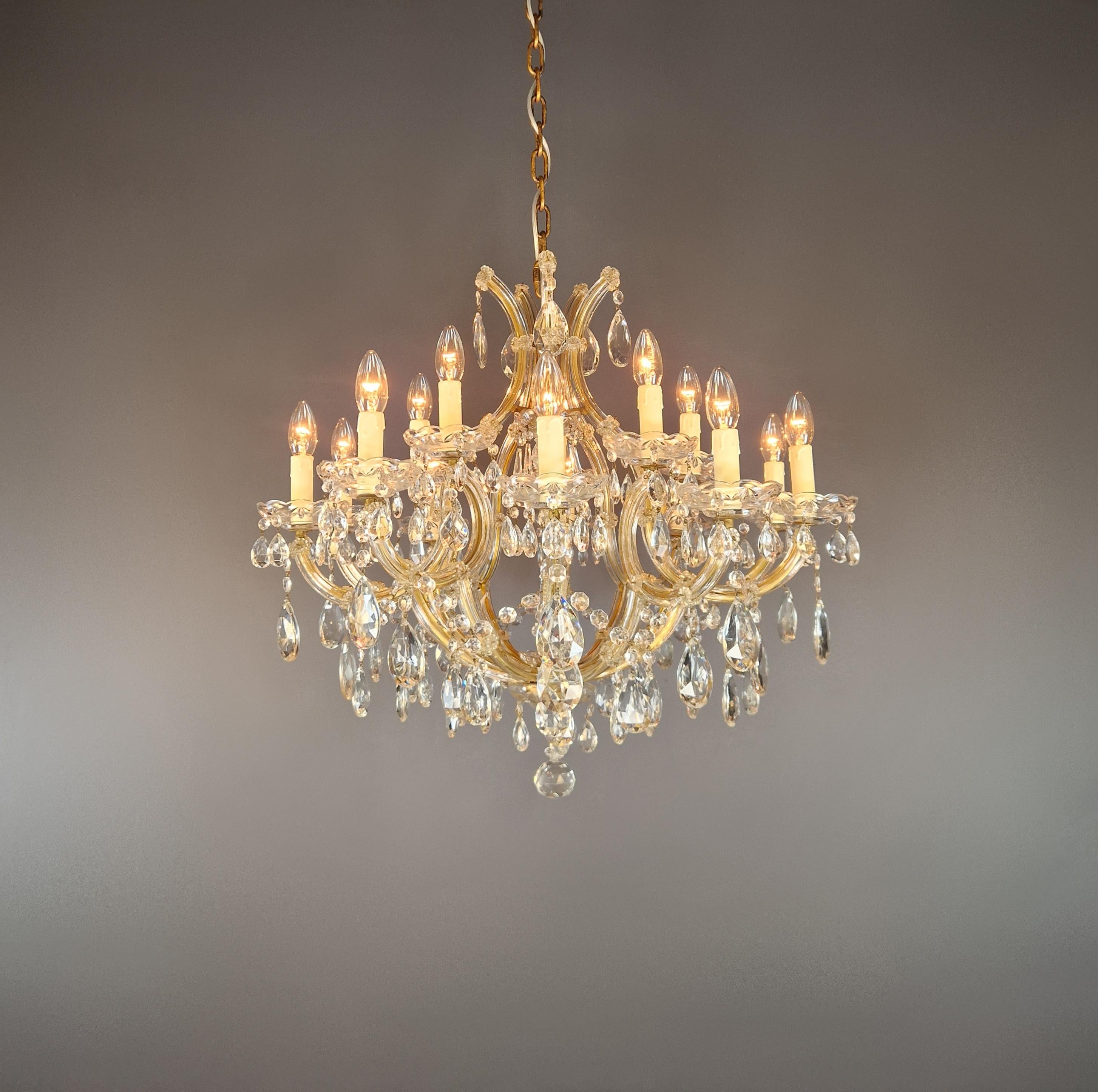 Ce magnifique lustre Marie-Thérèse est un véritable point d'orgue pour n'importe quelle pièce. Le cadre est entièrement recouvert de verre et somptueusement décoré de gouttes de cristal taillé de différentes formes et tailles, suspendues à de
