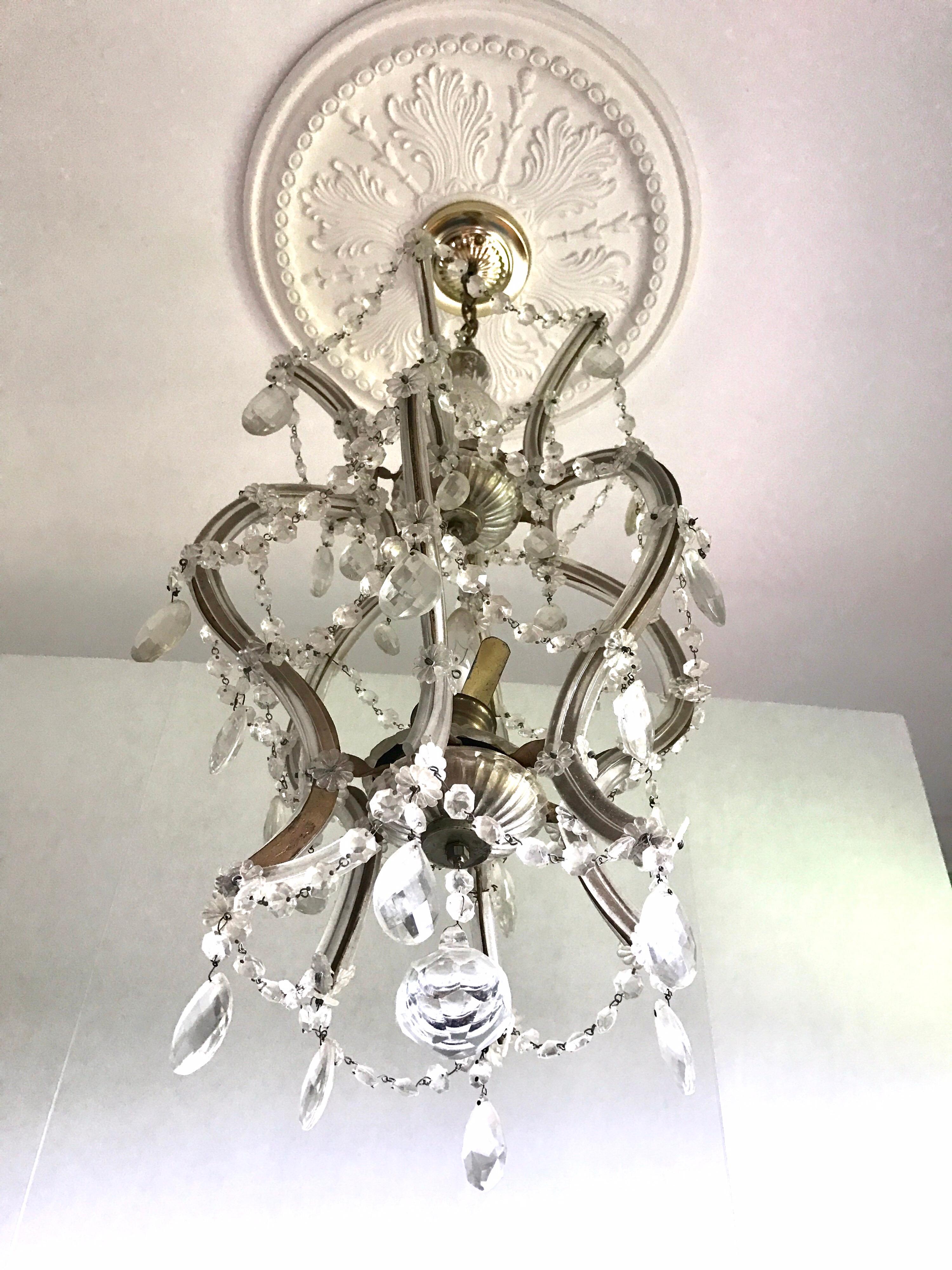 A lovely Maria Theresa chandelier (or hanging fixture) of crystal, glass and gilt metal featuring serpentine arms, each candle light with dangling pendants. Made in Italy.

U.S. wired and ready for display.