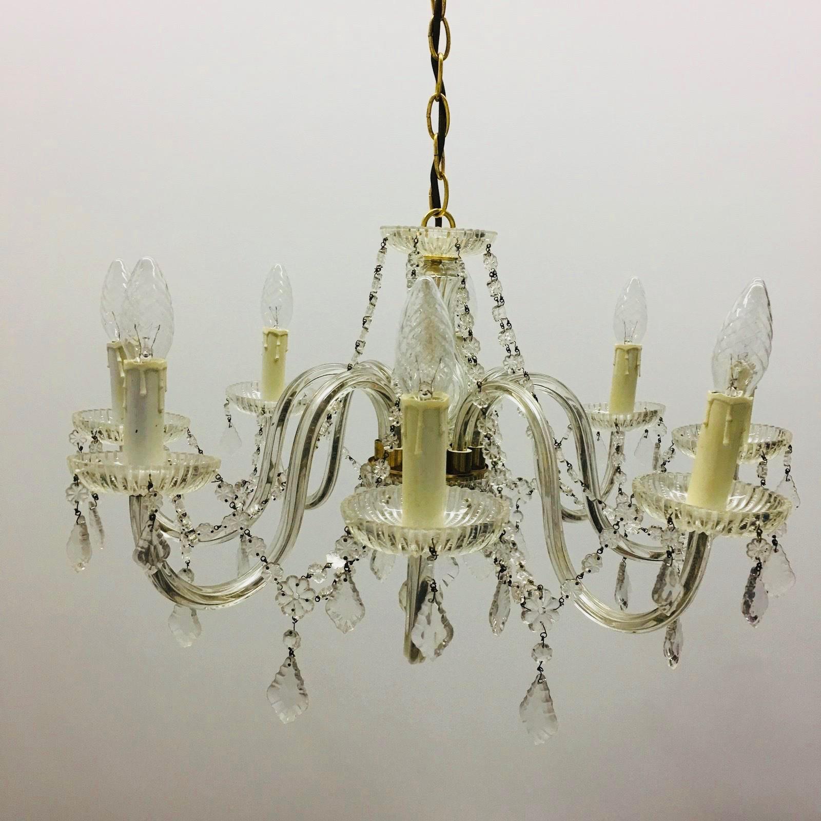 Gorgeous brass with cut crystal chandelier in Maria Theresa style made in the 1960s probably in Vienna. A beautiful form body. Eight flamed fitted with E14 sockets, rich hangings from the various faceted crystal. Found at an estate sale in Vienna,