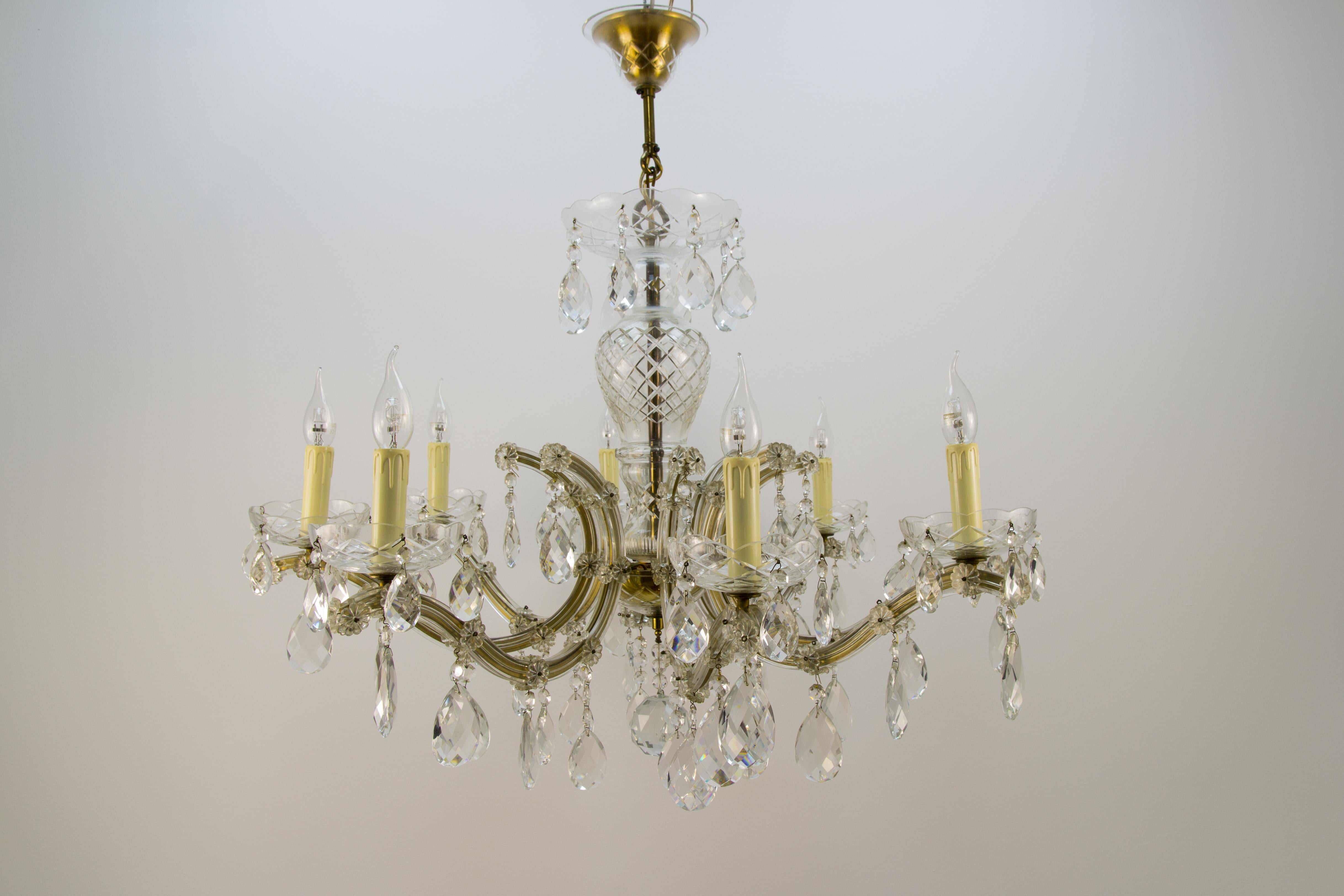 Beautiful Italian Maria Theresa style eight-light crystal chandelier. Brass and metal frame covered in glass with hanging crystal pendants, eight sockets for E14 size light bulbs.
Dimensions: Diameter 91 cm / 35.82 in; height 83 cm / 32.67 in.
The