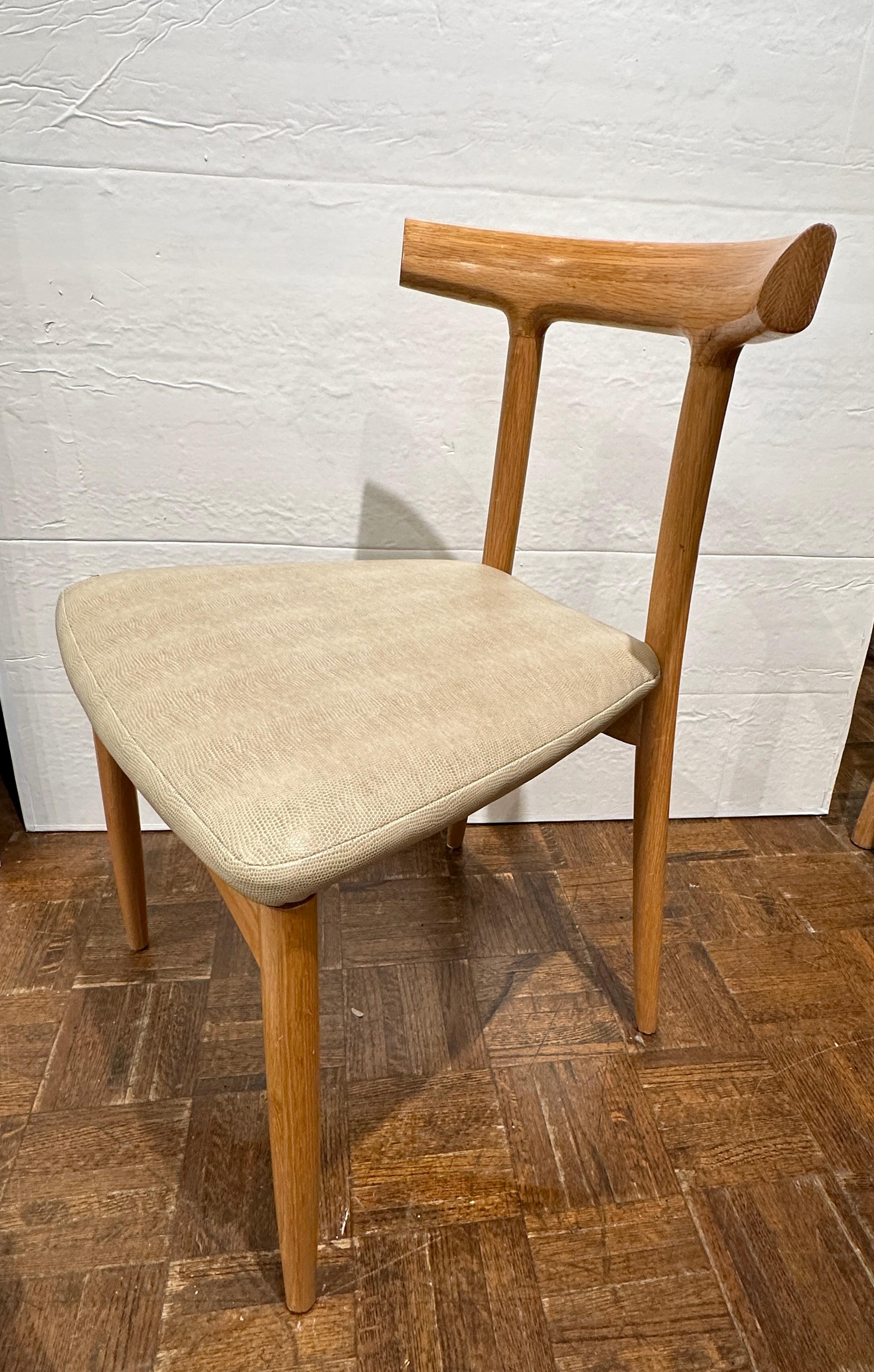 Set of 6 dining chairs yoke style by Maria Yee.  Wonderfully comfortable Mid Century Modern look with Asian flair.  Made of solid hard wood, clear bleached oak, 
Yoke back carved for comfort.  Seats are covered in faux shagreen leather.
( faux