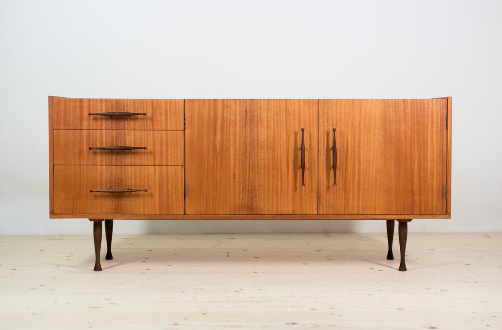 Introducing the sideboard designed by Marian Grabiński – an exquisite masterpiece that seamlessly blends the timeless elegance of Polish Design with the iconic flair of Mid-Century Modern aesthetics, transporting you straight into the chic ambiance