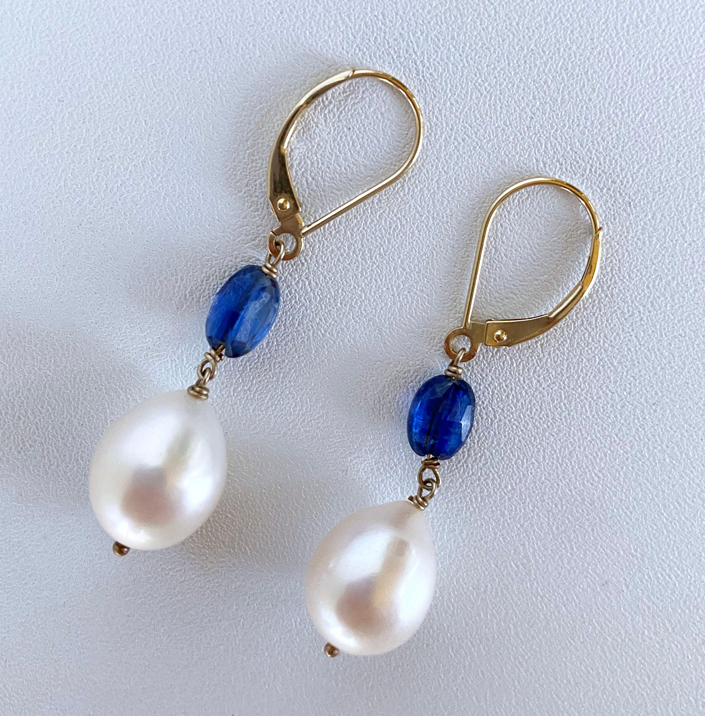 Gorgeous and simple pair of earrings made by Marina J. In Los Angeles. This pair features two gorgeous flat and faceted Blue Kyanite oval beads from which slightly Baroque Cream Pearls hang. The Kyanite’s translucency allows it to radiate stunning