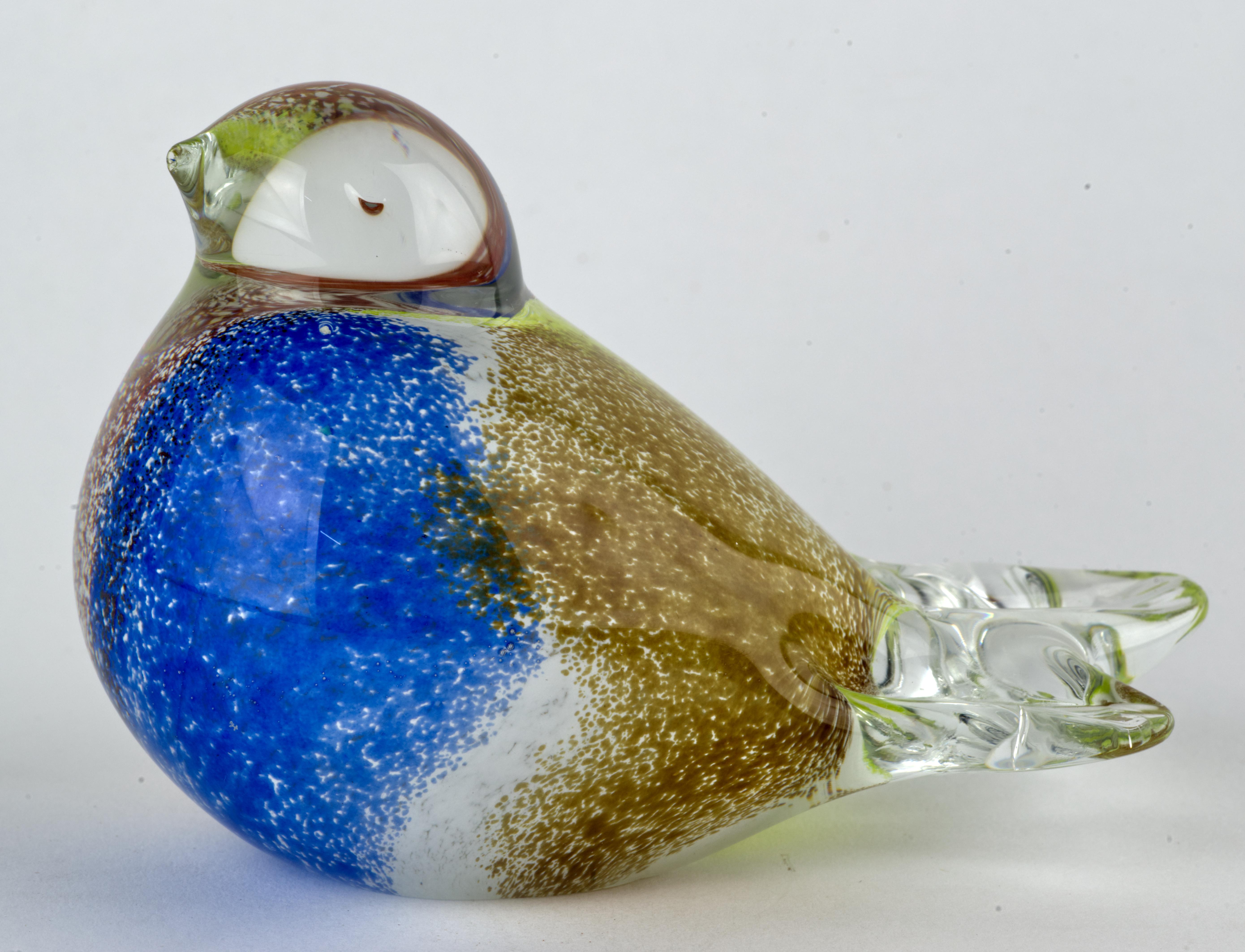 Delicate bird figurine or paperweight was made in sommerso technique, with colored glass gather cased over with clear glass. Gentle transitions between blue, red, light brown, and yellow pigments used on colored gather add depth and movement to