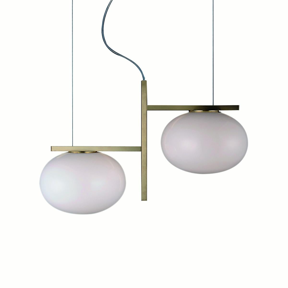Suspension lamp 'Alba' designed by Mariana Pellegrino Soto in 2017.
Suspension lamp giving diffused light in polished opaline blown-glass. Satin brass or anodic bronze finish structure with rectangular profile. Manufactured by Oluce, Italy.

The