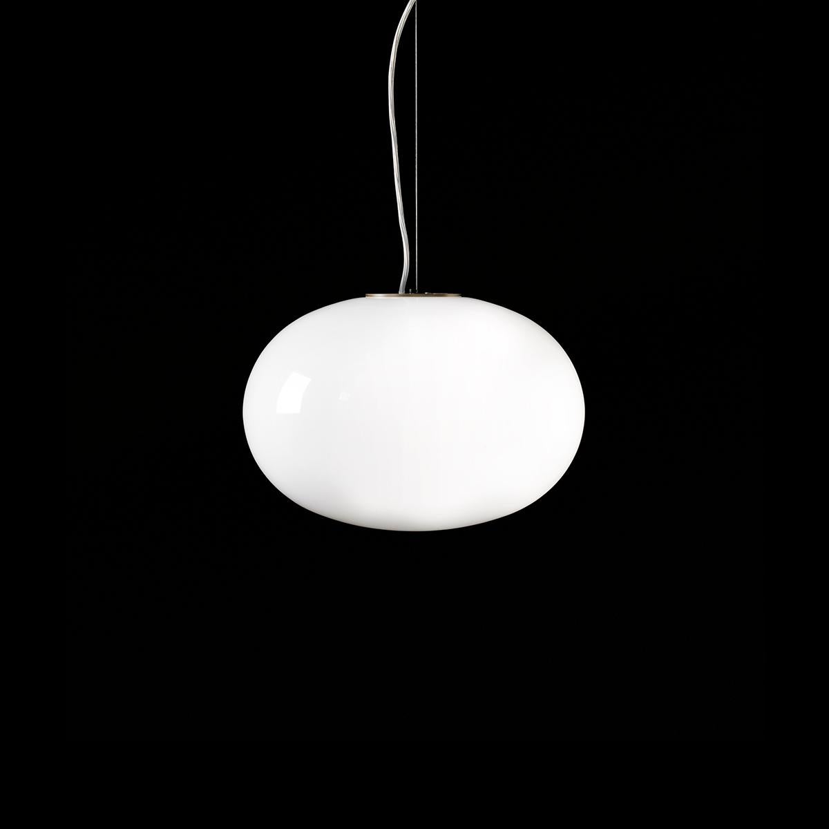 Suspension lamp 'Alba' designed by Mariana Pellegrino Soto in 2017.
Suspension lamp giving diffused light in polished opaline blown-glass. Satin brass finish structure. Manufactured by Oluce, Italy.

The concept of Alba starts with a very simple