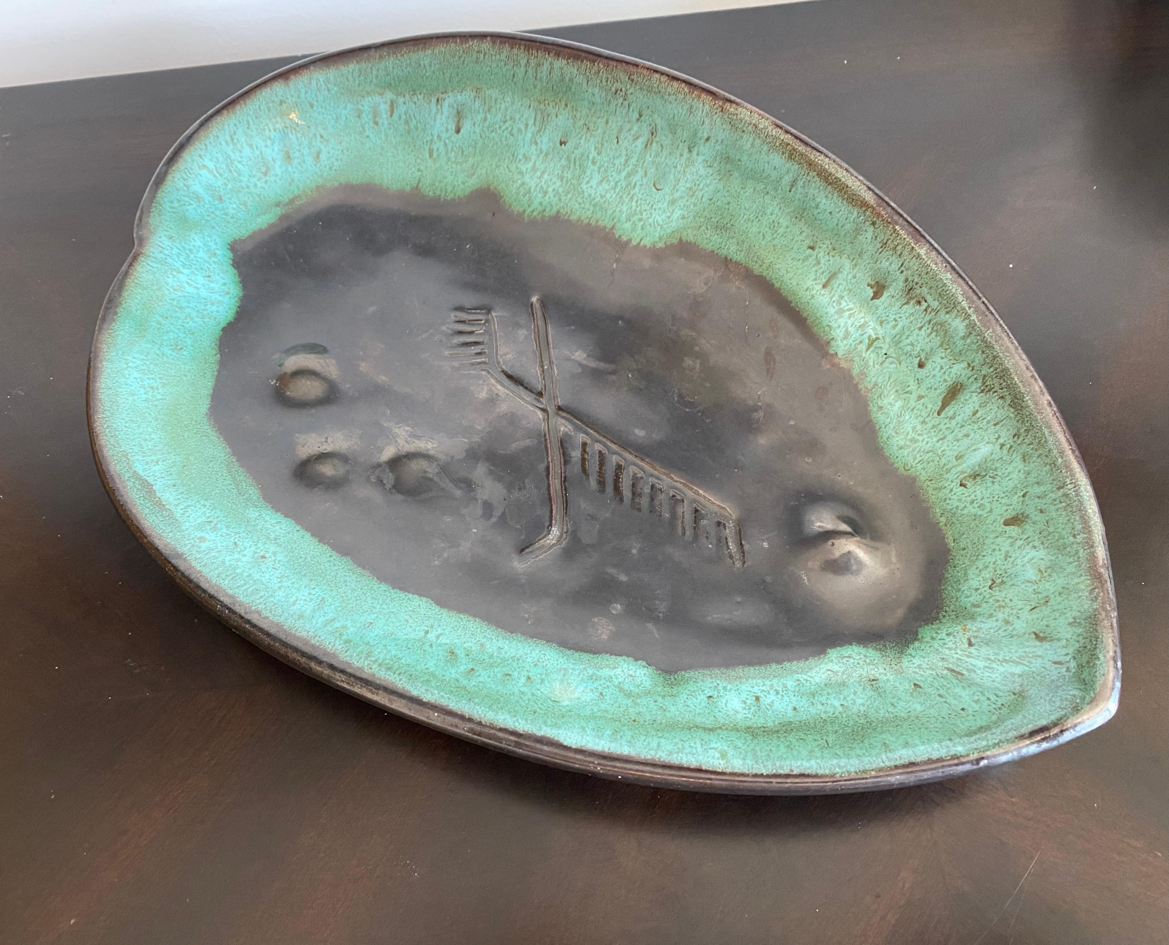 A beautiful 1940s asymmetrical leaf platter made by American studio potter, Mariana van Allesch. Signed.
Biography:

Marianna von Allesch was born Maria Anna Steudel in Germany.
Von Allesch emigrated to the United States in 1928 and by the late