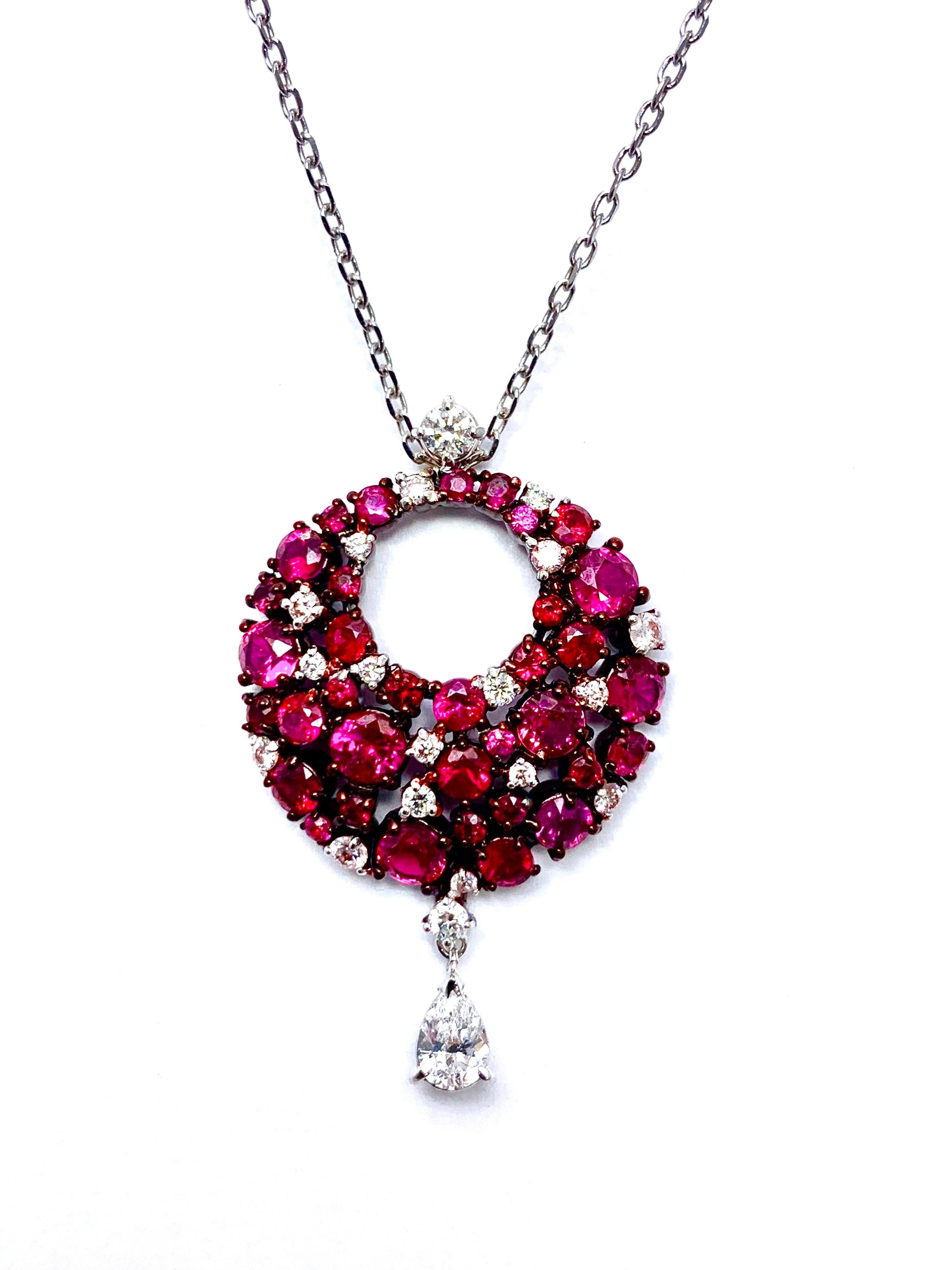 Exquisite Ruby and Diamond Pendant, part of the Eclipse Collection of Mariani. Features multiple shapes and hues of Rubies and Diamonds arranged in this circle and finished with a pear shape diamond drop at the base.  There is a total of 2.25 carats