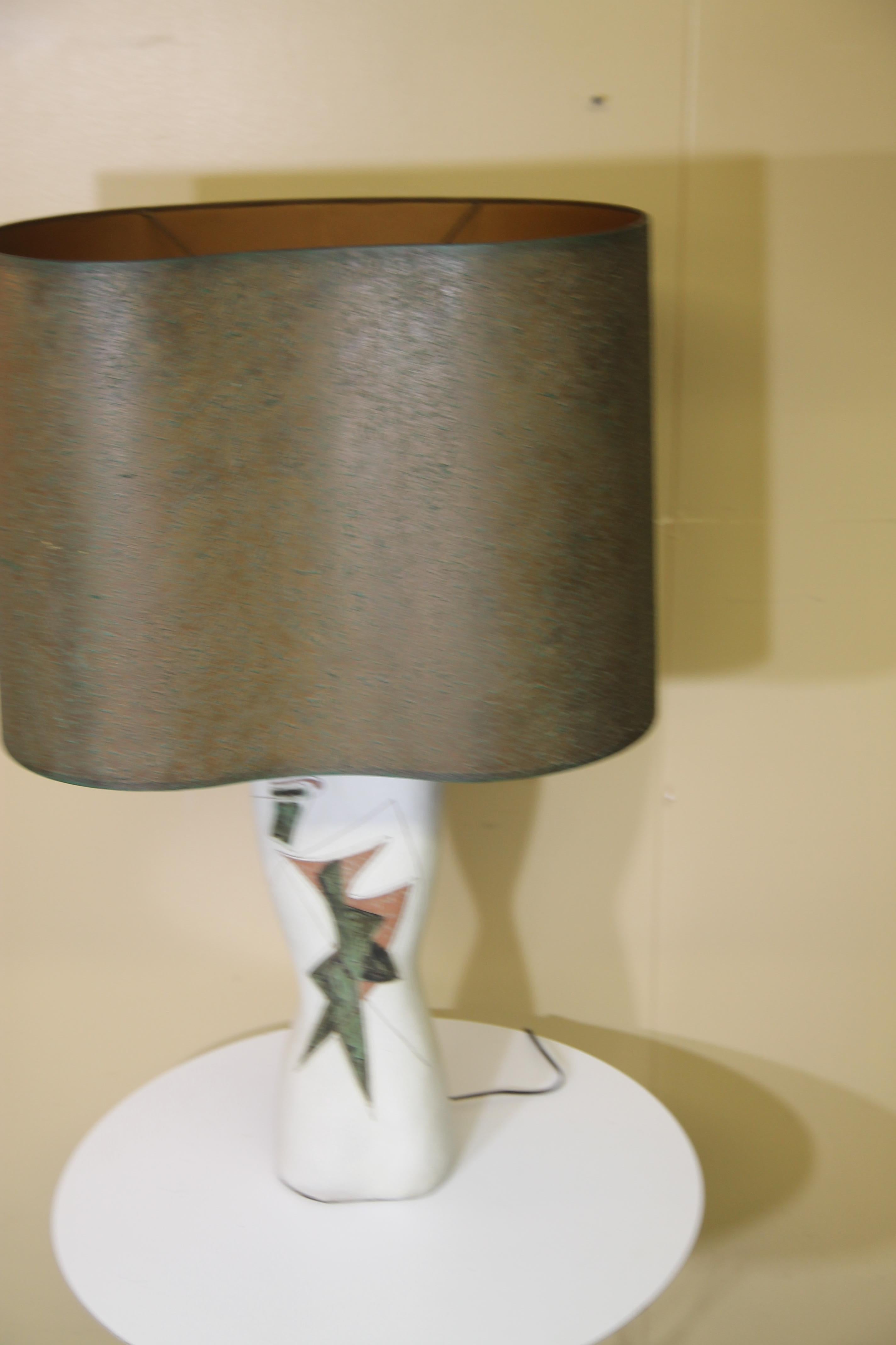 Wonderful abstract designed lamp from Marianna von Allesch. This lamp retains is original green/brown shade. This piece is stunning in person.
Shade is 21.75 x 16 x 16
Overall height of the lamp with the shade is 34.75
This lamp should be shipped