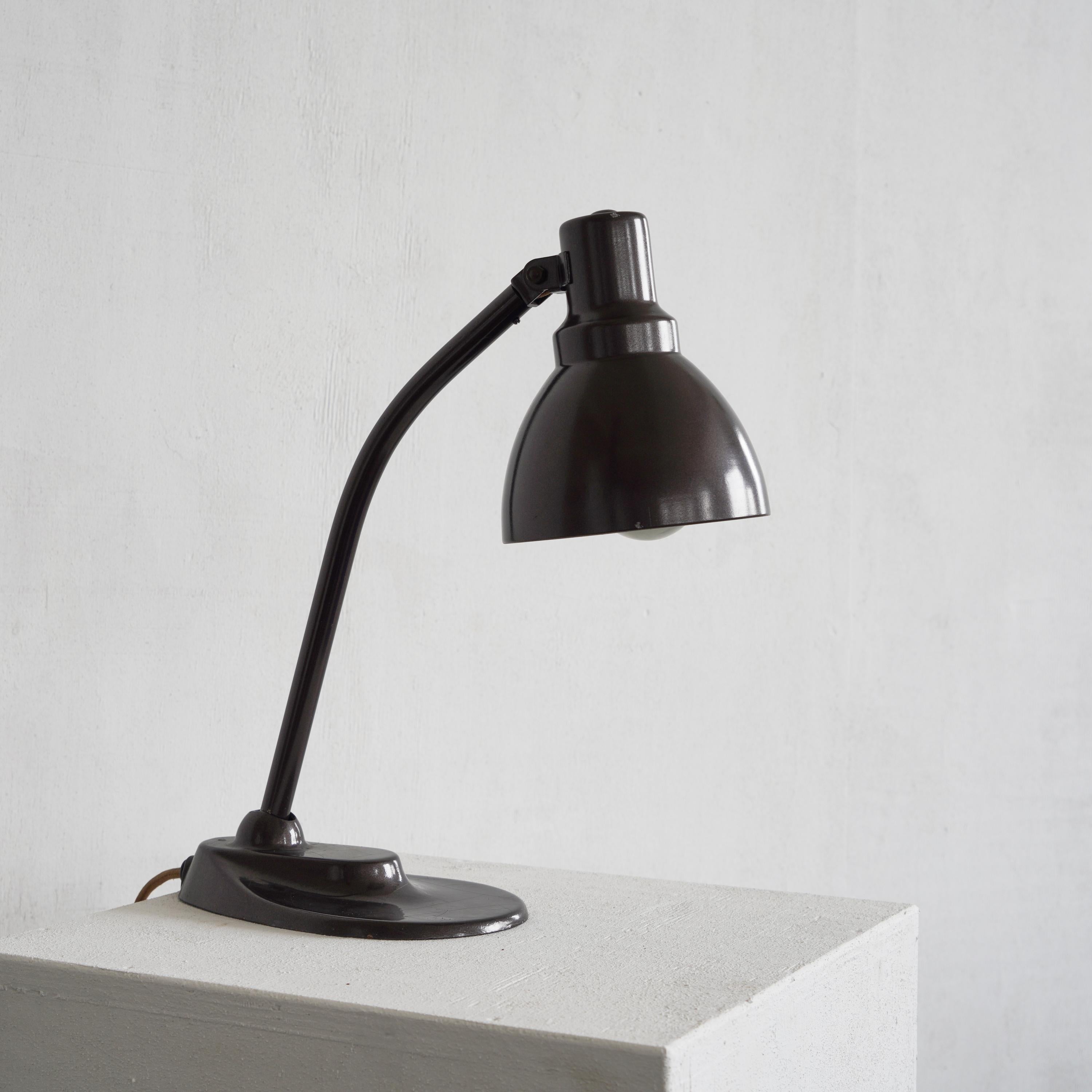 This desk lamp is a famous design by Bauhaus greats Marianne Brandt and Hin Bredendieck.

Showing a very simple but bold design this lamp is a true Bauhaus gem. 

Our example is in very good vintage condition with a nice patina and works