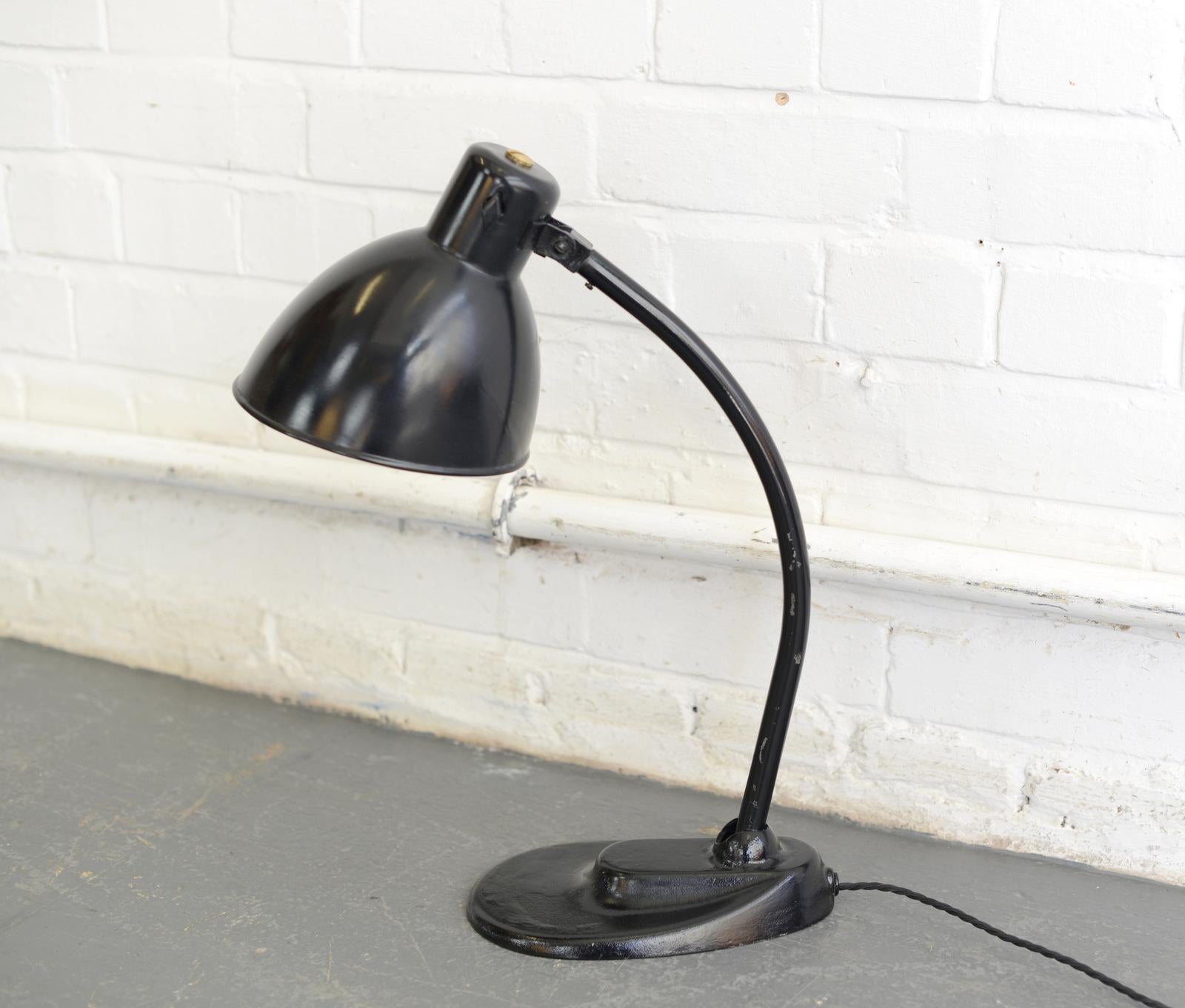 Marianne Brandt Kandem desk lamp, circa 1920s.

- Cast iron base
- Angled steel shade
- Articulated arm and shade
- Original on/off switch
- Designed by Marianne Brandt for Kandem
- German, 1920s
- Measures: 49 cm tall x 14 cm wide x 22 cm