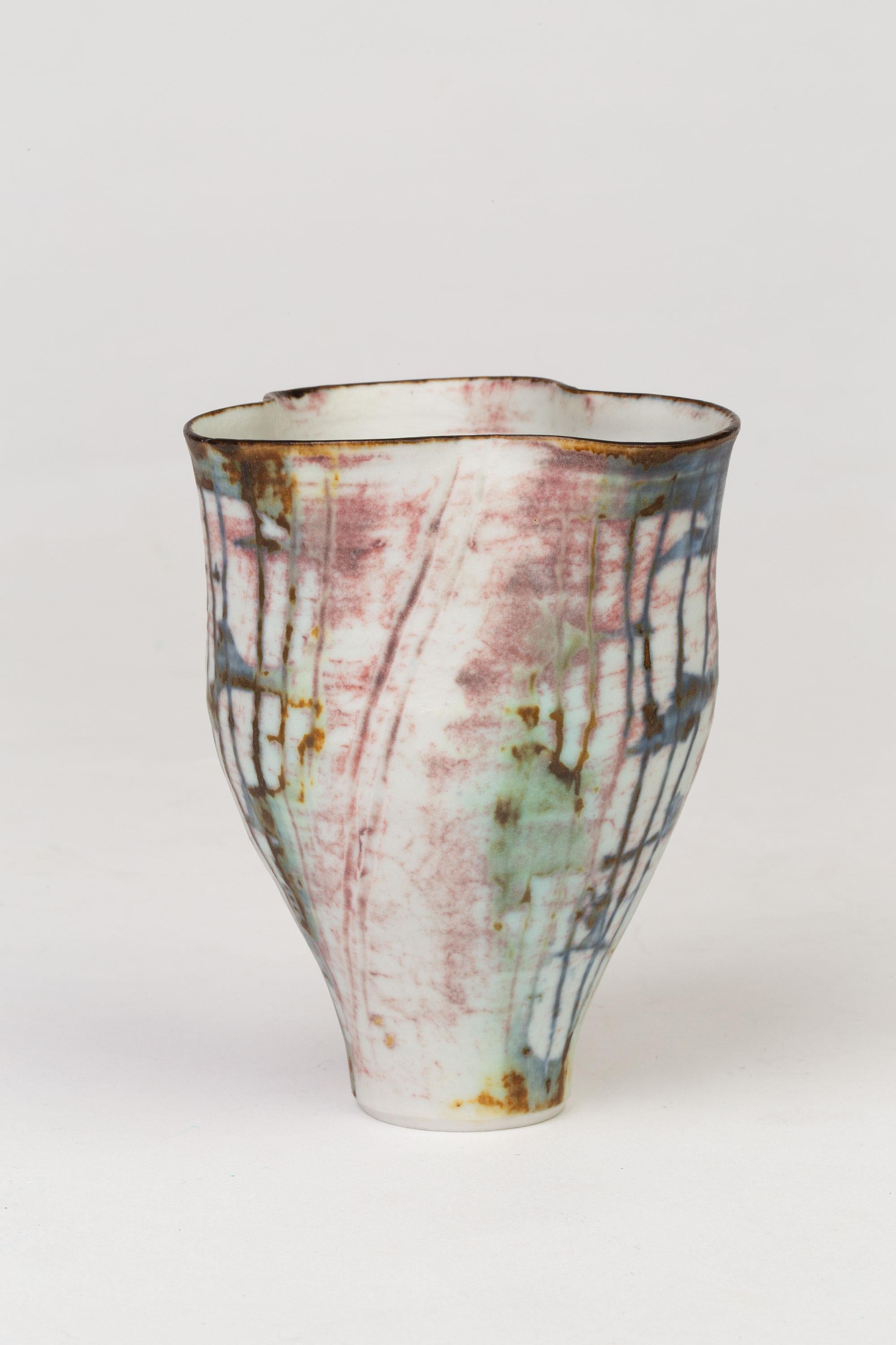 A fine British studio pottery porcelain fluted vase with wax linear decoration by renowned potter Marianne De Trey (1913-2016) and dating between 1980 and 1985. This very finely made vase has a pinched top creating three rounded edges and is