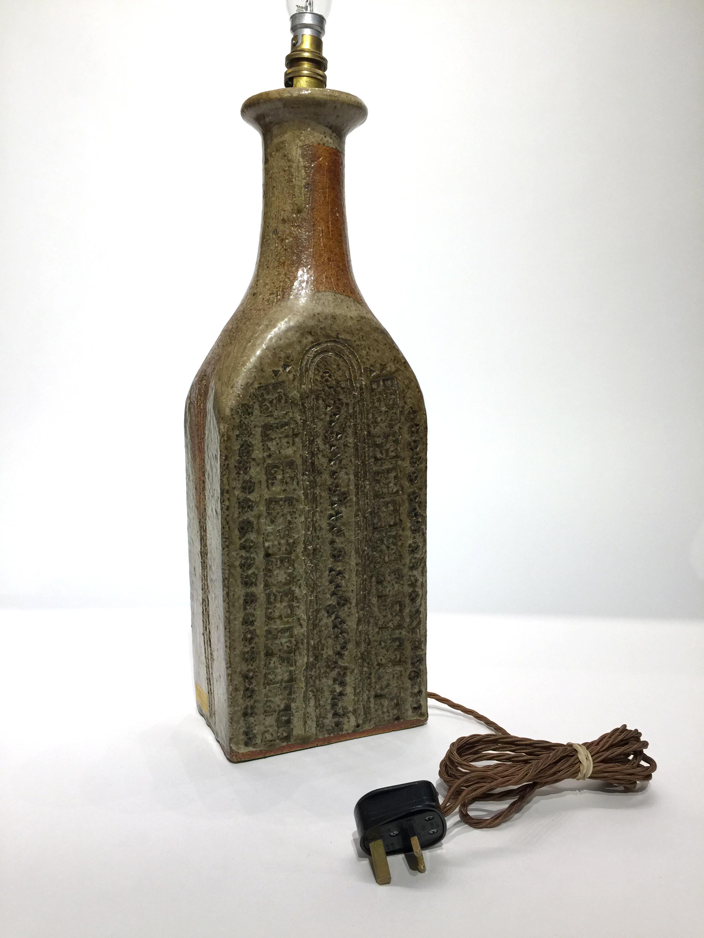 This stoneware table lamp was designed by Marianne de Trey CBE (1913-1916) for Dartington Pottery, Devon (now Grayshott Pottery). de Trey was a pioneer of British studio pottery whose designs played a significant role in the revival of ceramic craft