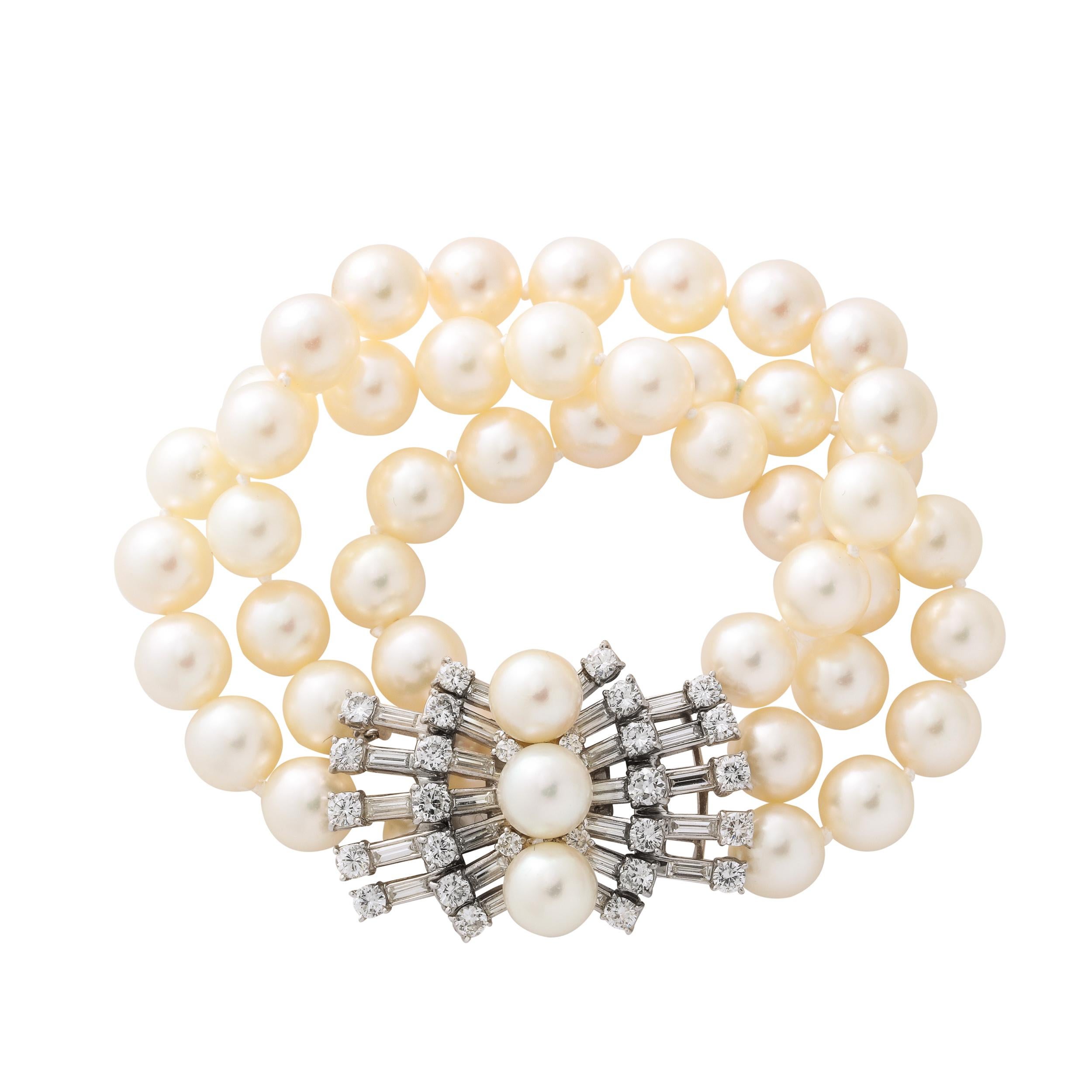 Hailing from the estate of Pauline Ireland and designed by the illustrious Marianne Ostier, this gorgeous triple strand cultured pearl bracelet terminates in a dramatic diamond clasp. Set in platinum and 14kt white gold, the piece features 28 round